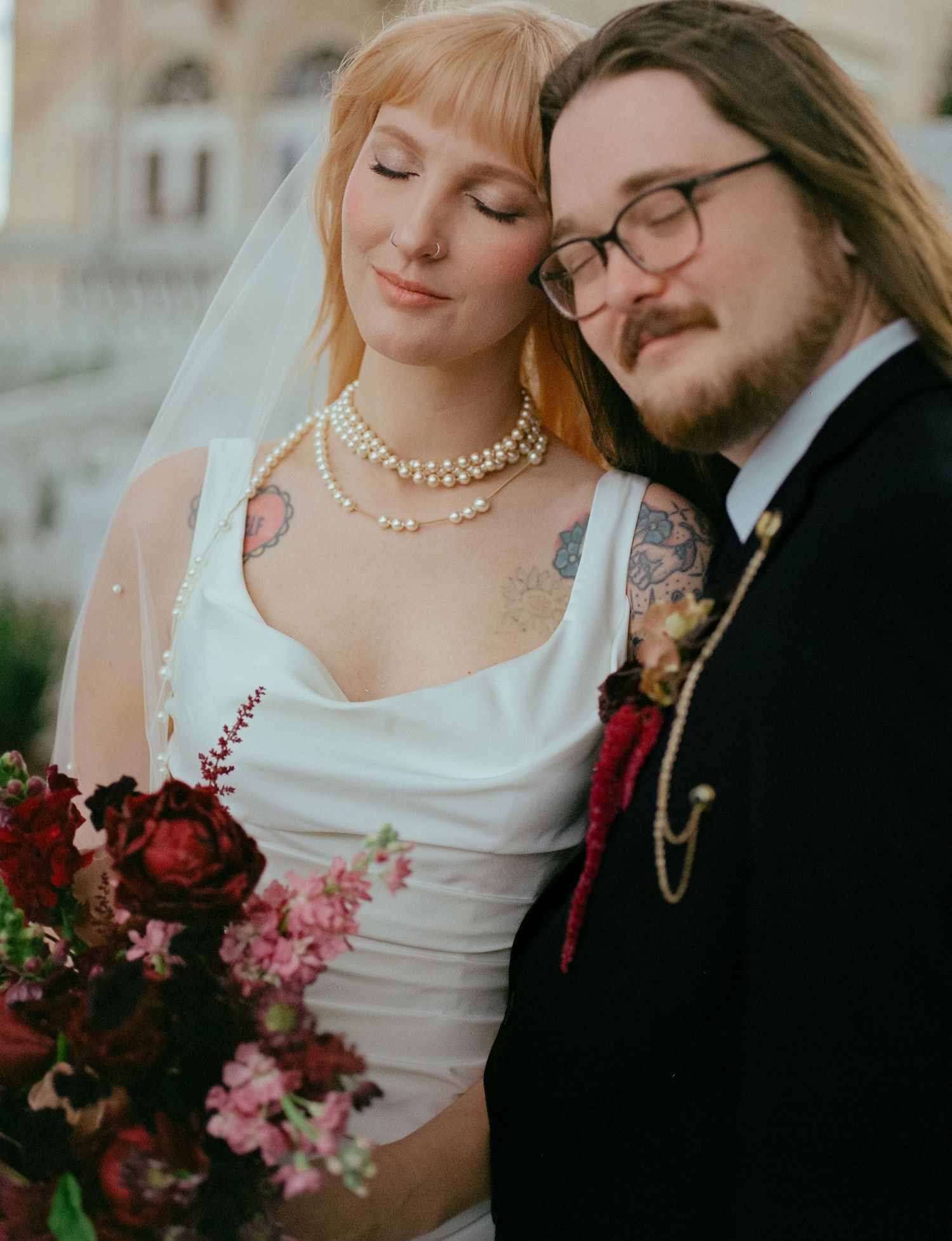 A tender wedding moment captured in a series of intimate portraits with burgundy floral accents.