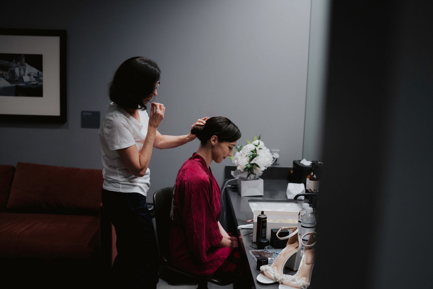 People working in a modern office environment with white walls and natural lighting.