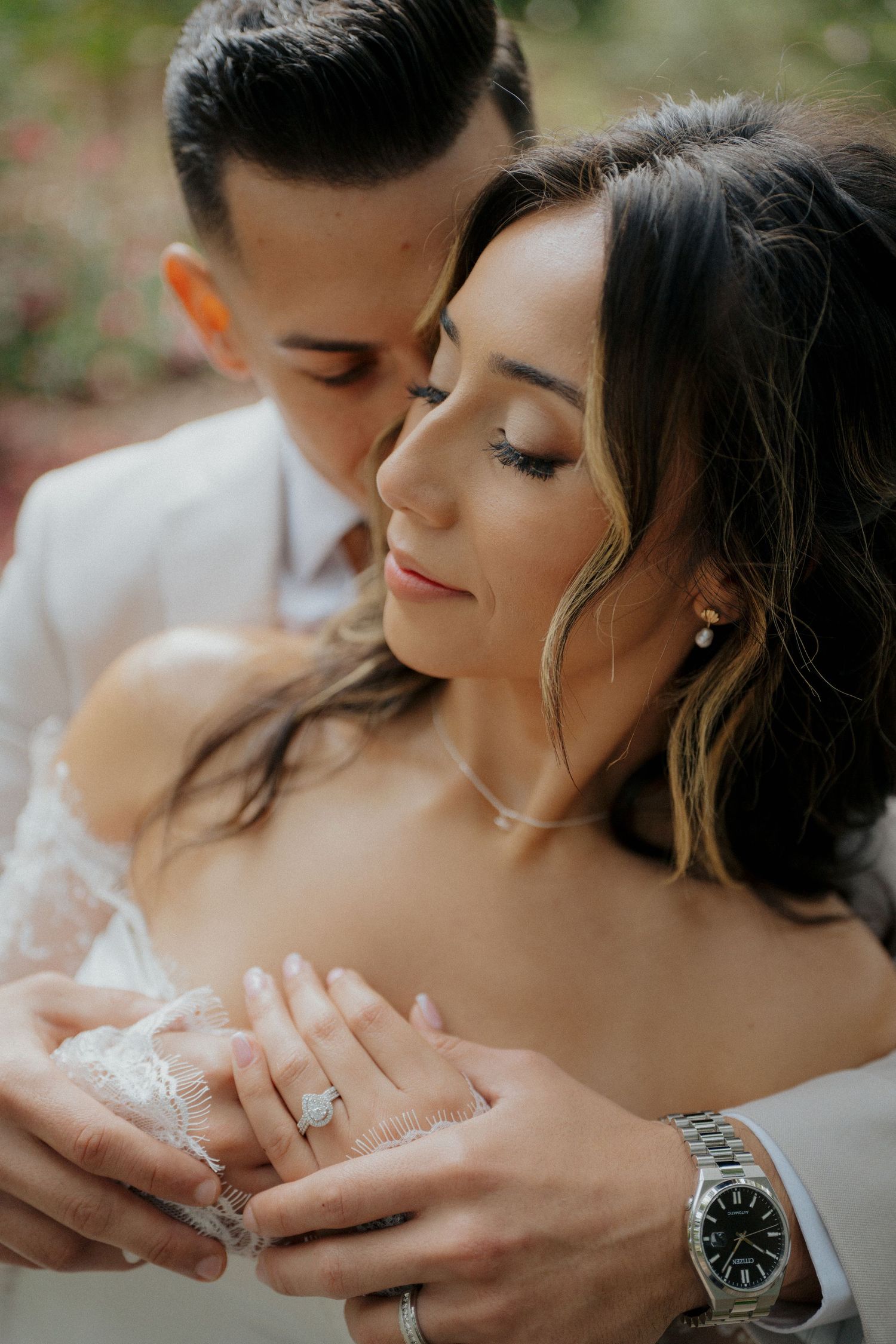 Intimate wedding portrait showing tender moments between a couple in formal attire.