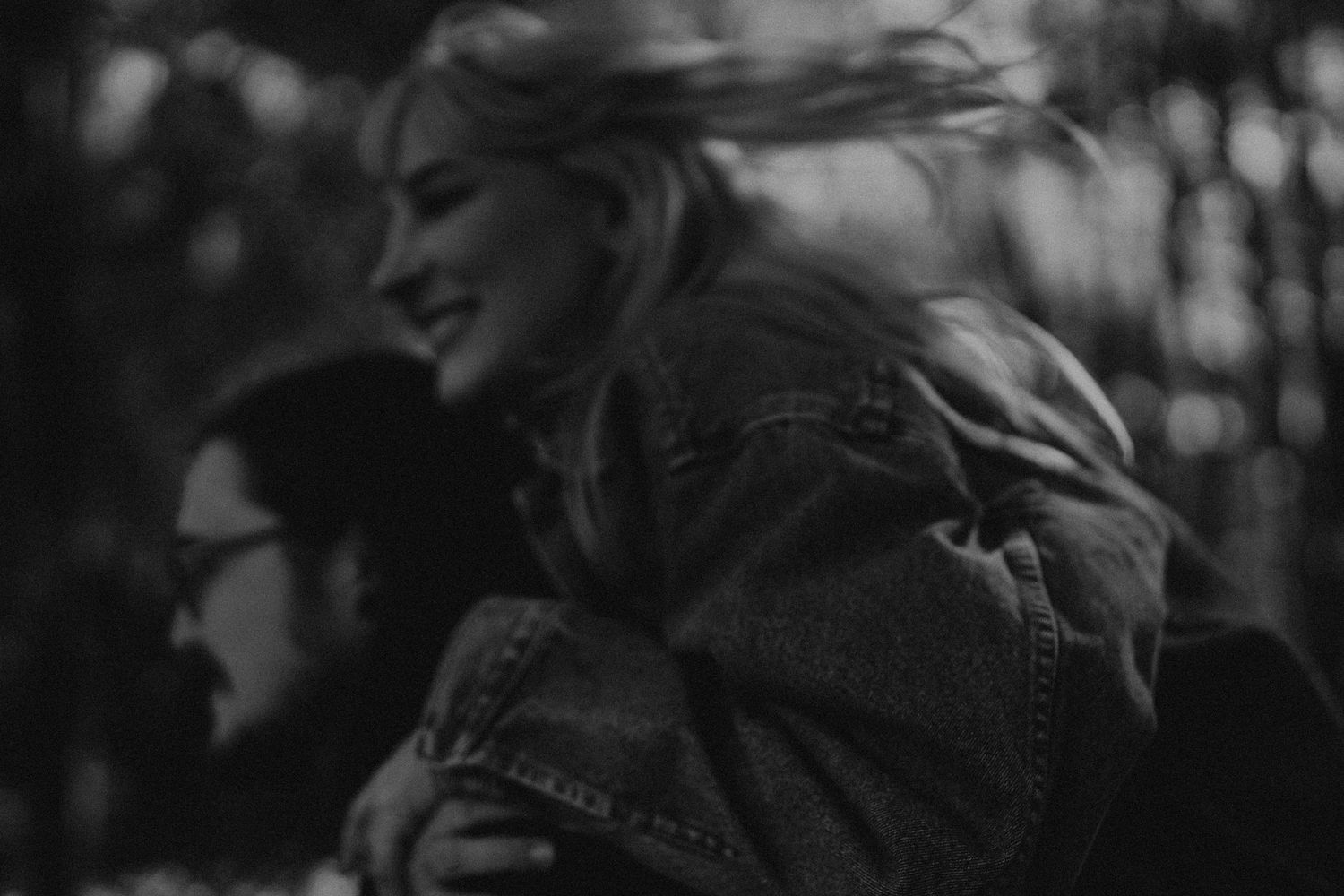 A grainy black and white photo capturing a carefree moment between two people.