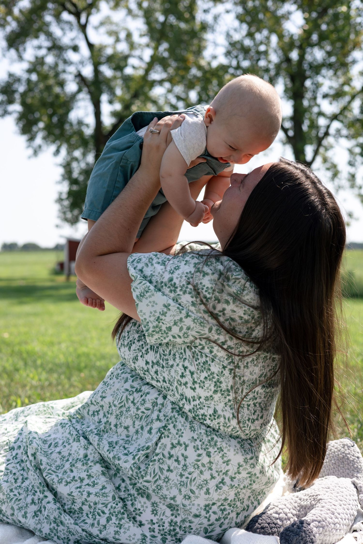 Mother holding her young son during an outdoor motherhood photography session.