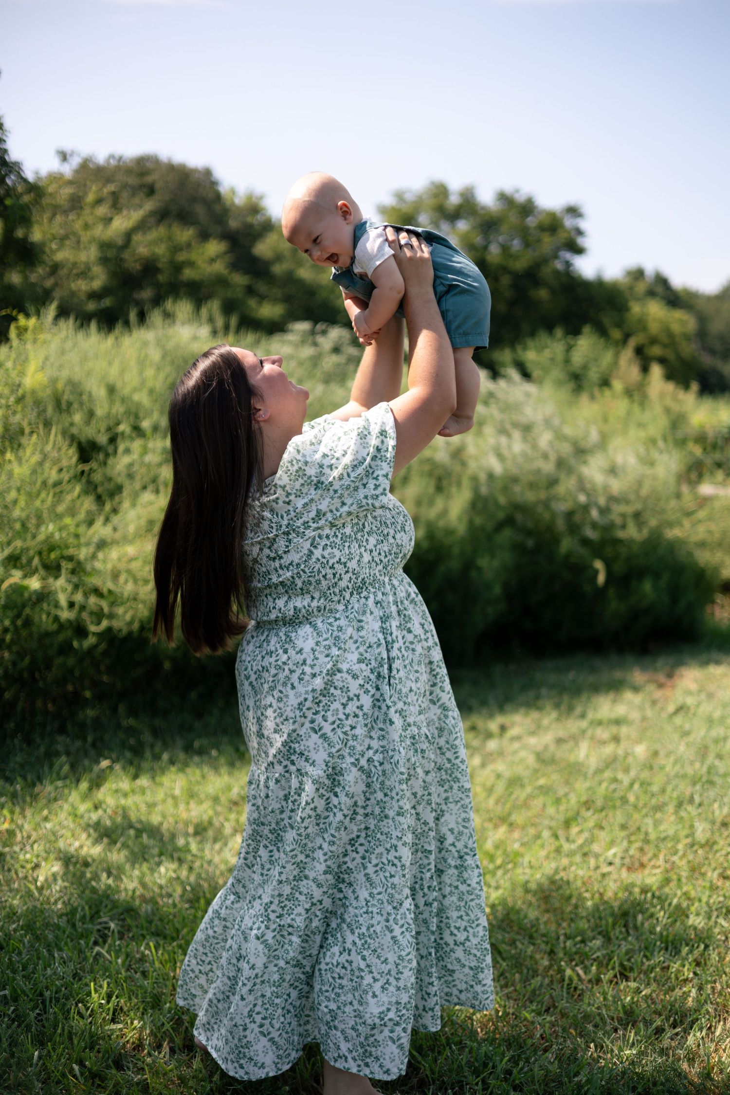 Mother holding her young son outdoors during a motherhood photography session.