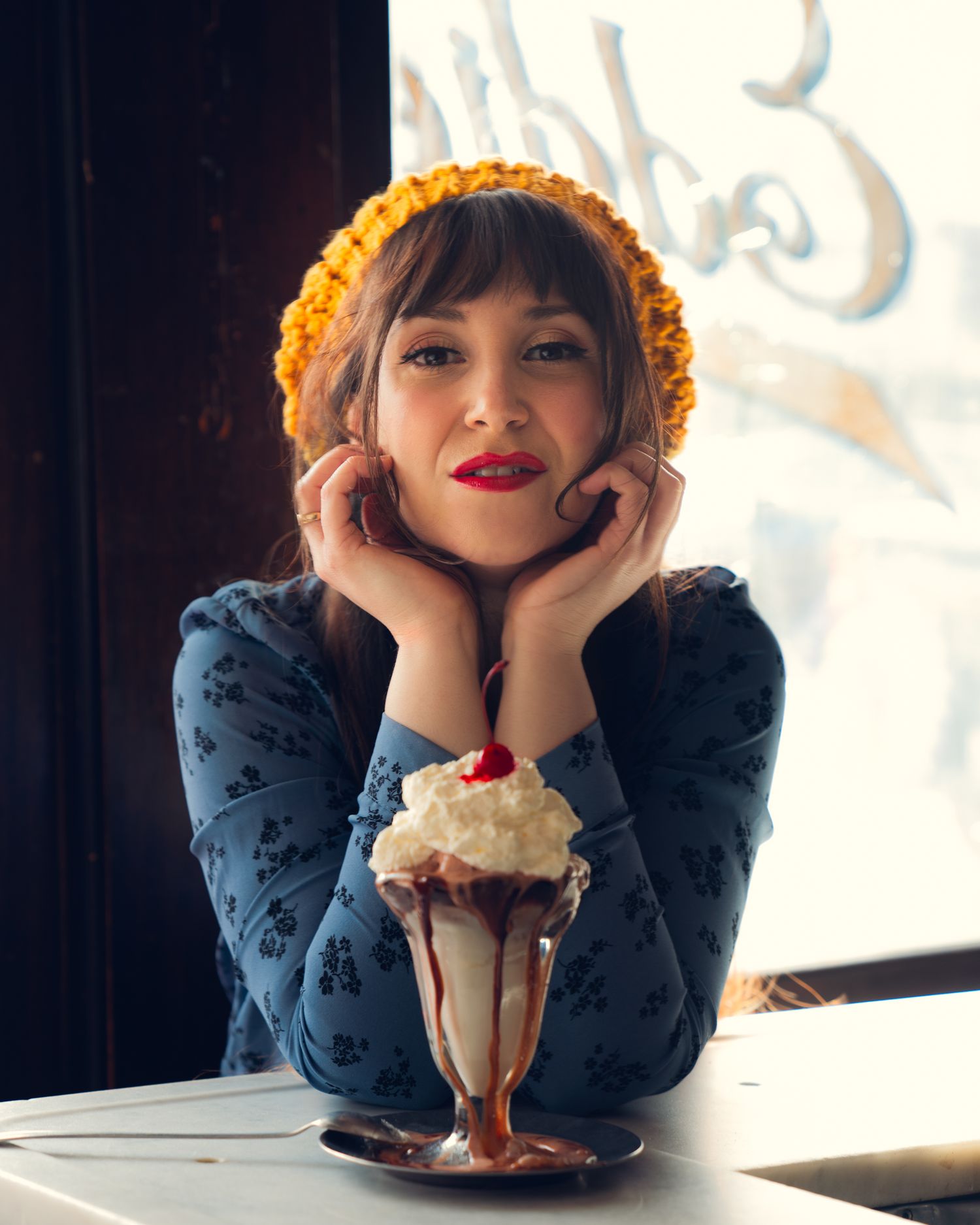 Editorial photography, portrait of vintage woman with ice cream sundae in the historic Eddies Sweet Shop in Forest Hills Queens New York Cit