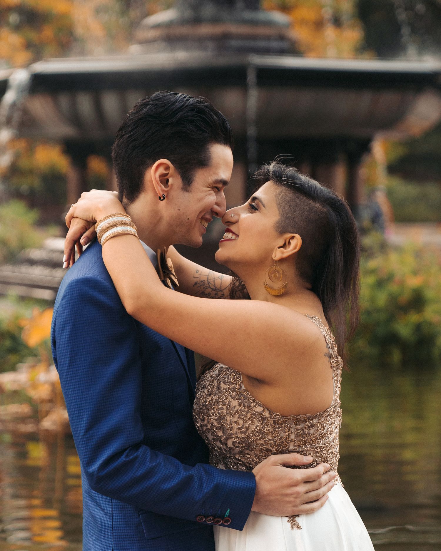Married couple kissing in front of fountain in Central Park during elopement photo session.