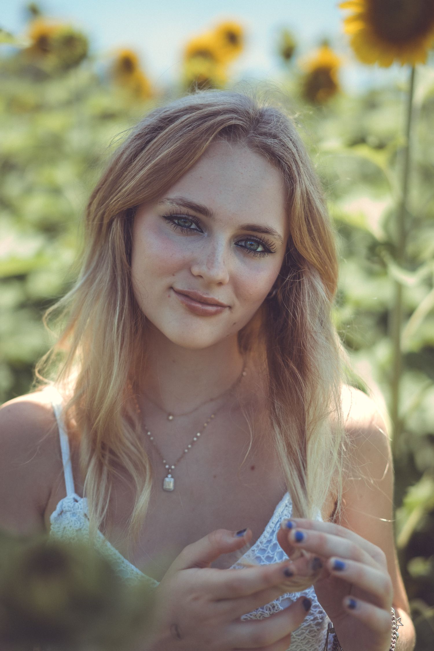 High school senior girl in sunflower field
