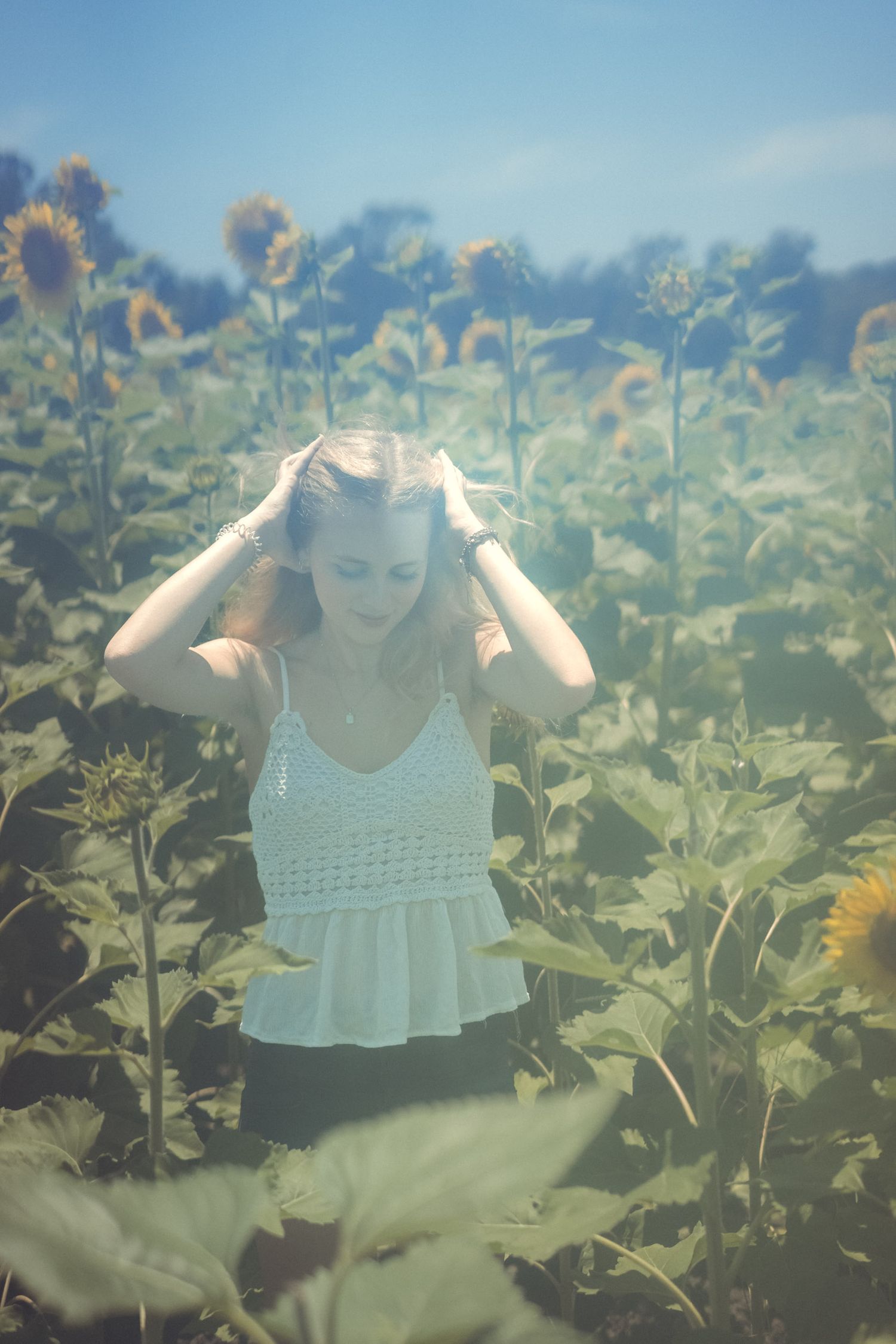 High school senior girl in sunflower field