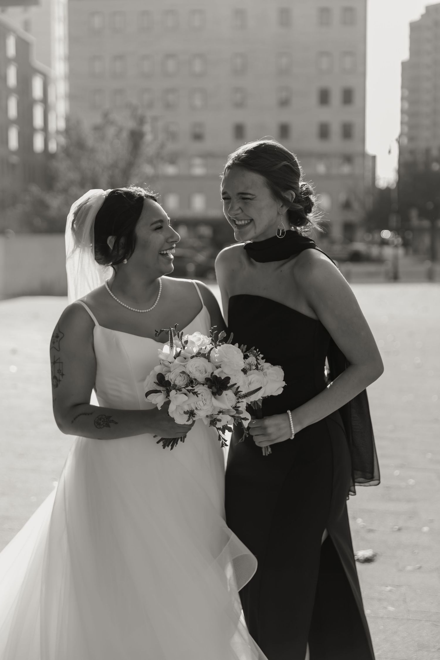 A sequence of candid black and white wedding photos showing two people embracing and laughing together outdoors.