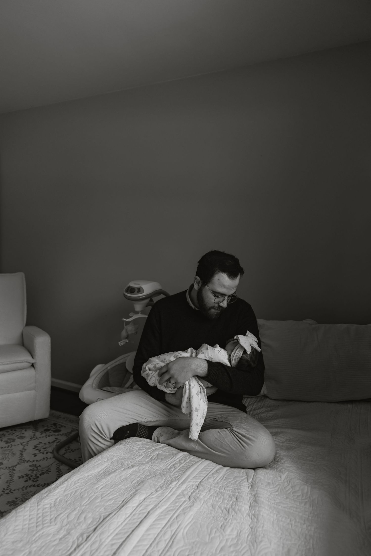 A series of black and white photos showing someone lying on a bed in a dark room.