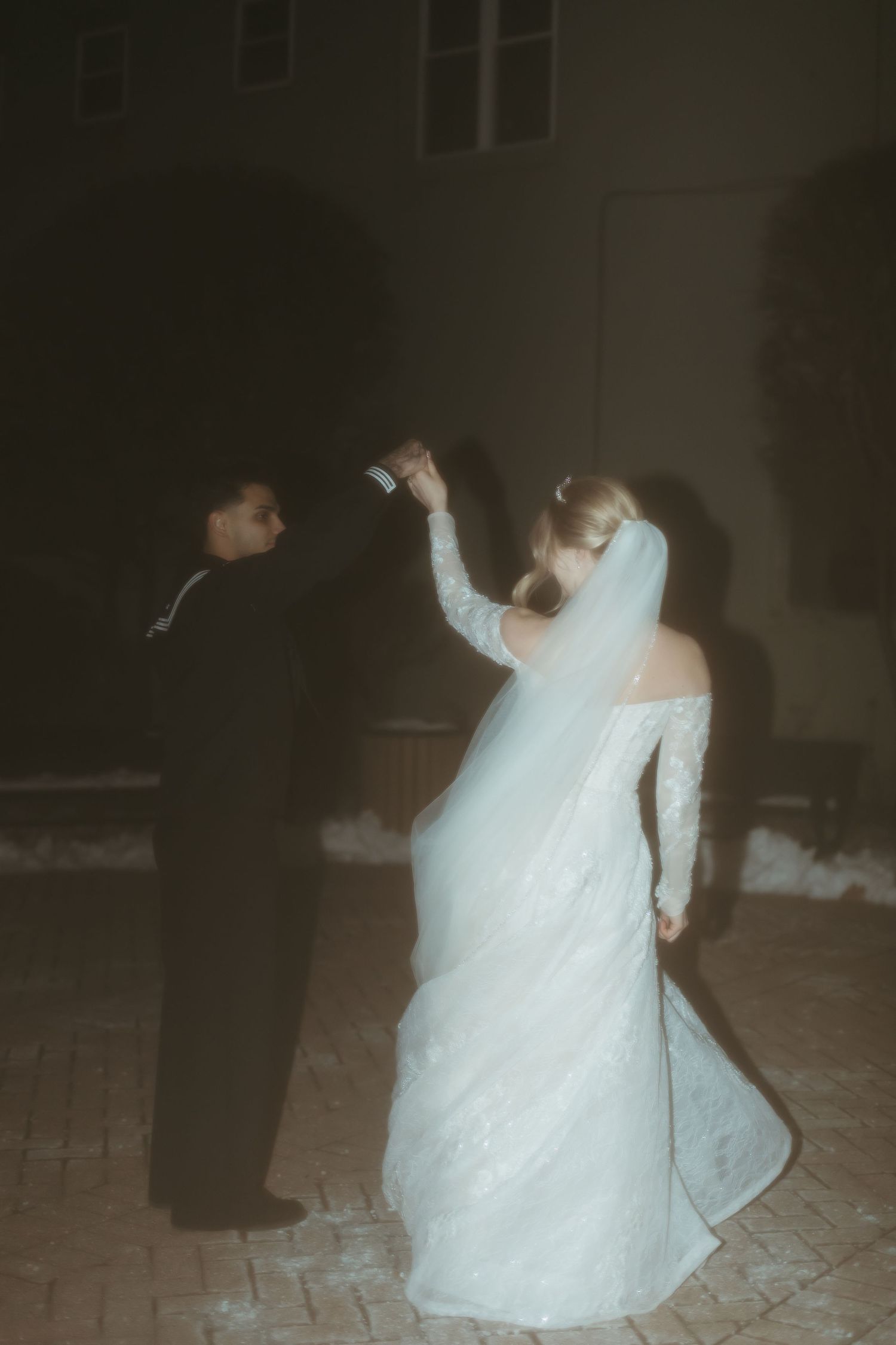 Artistic black and white photo of newlyweds dancing at their reception.