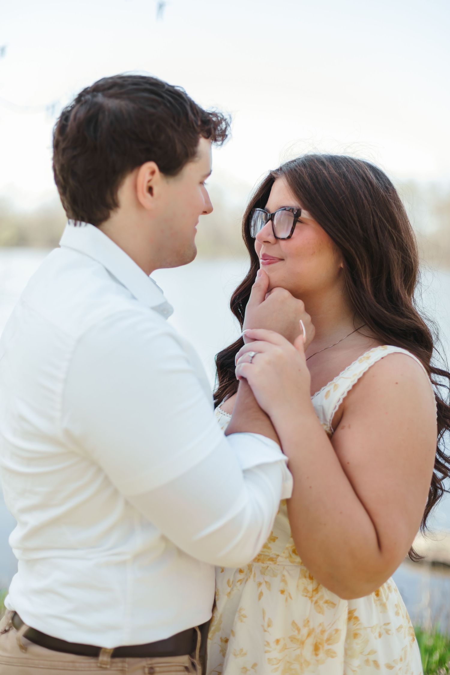 A tender moment captured in a series of photos showing affection between two people in white and yellow outfits outdoors.