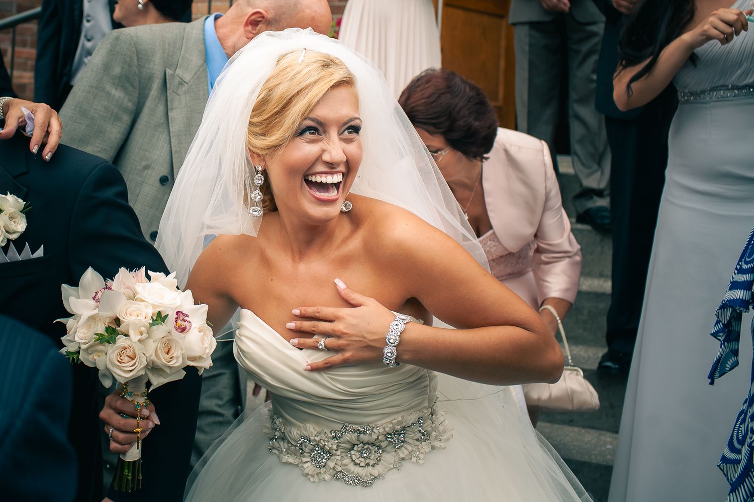 Joyful candid moment during a wedding celebration outdoors.