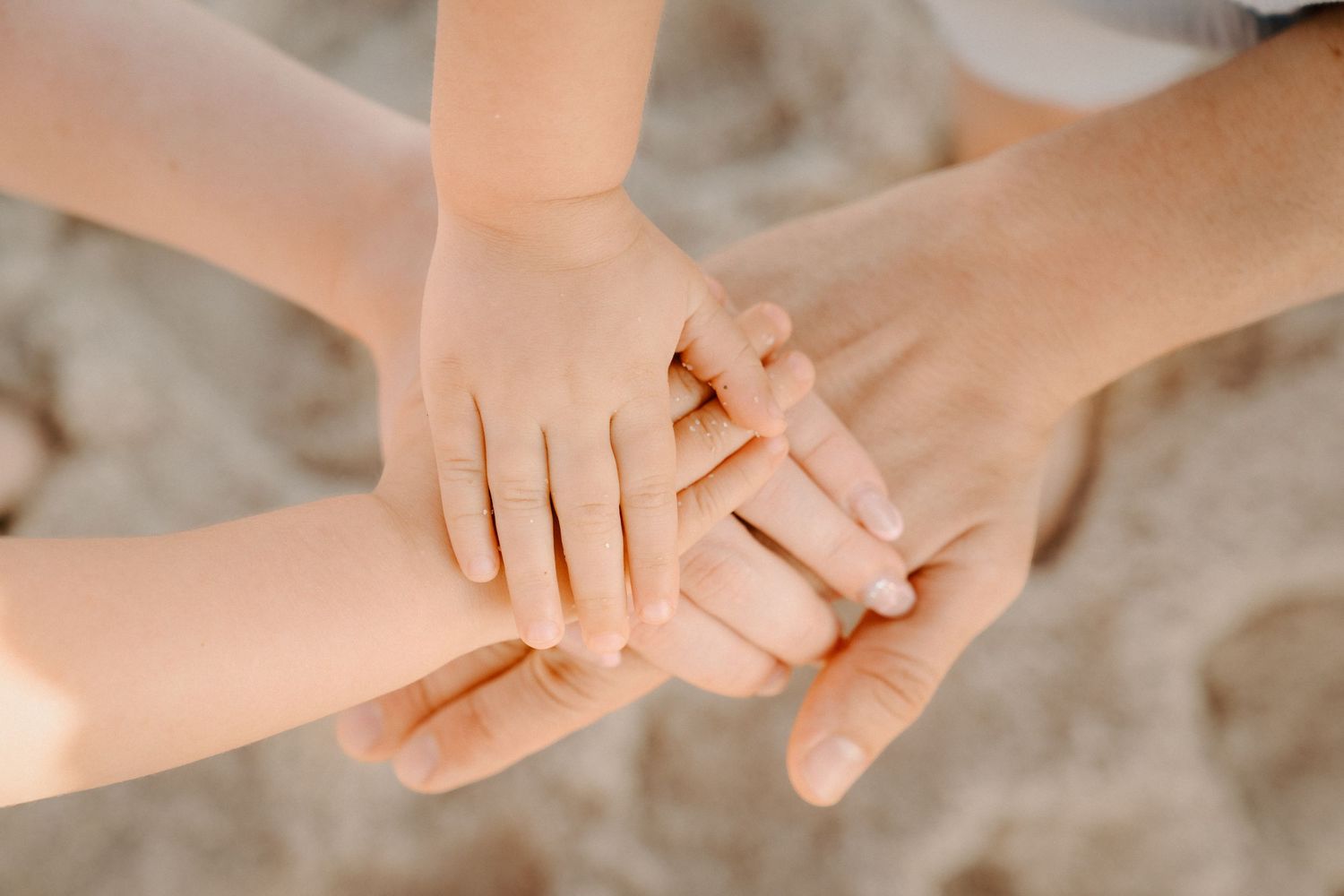 Candid Miami Beach family photoshoot – close-up of hands joined together