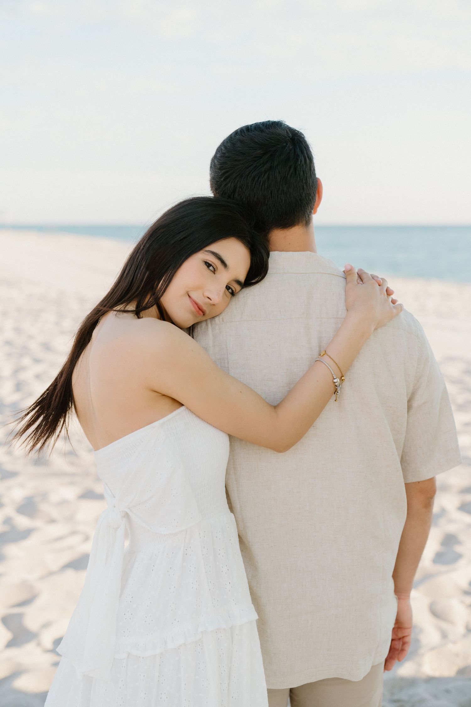 Romantic beach photoshoot in Miami – woman resting her head on her partner's shoulder