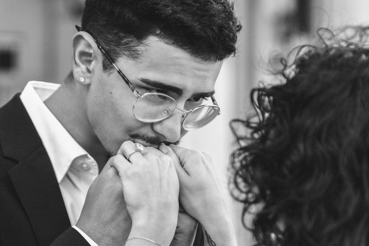 Miami courthouse engagement (elopement/mini wedding) photoshoot – groom kissing partner’s hand in an intimate moment