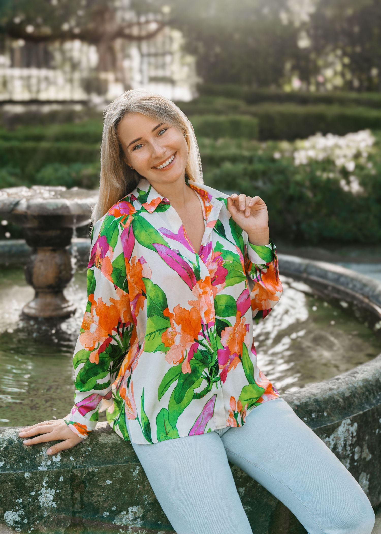 Portrait of a woman smiling at the camera during a photoshoot, captured in a joyful and candid moment