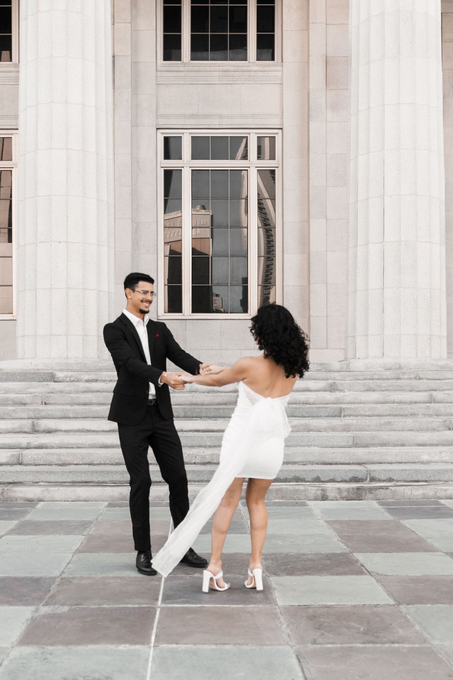 Candid Miami engagement (elopement/mini wedding) photoshoot – couple spinning together with joy