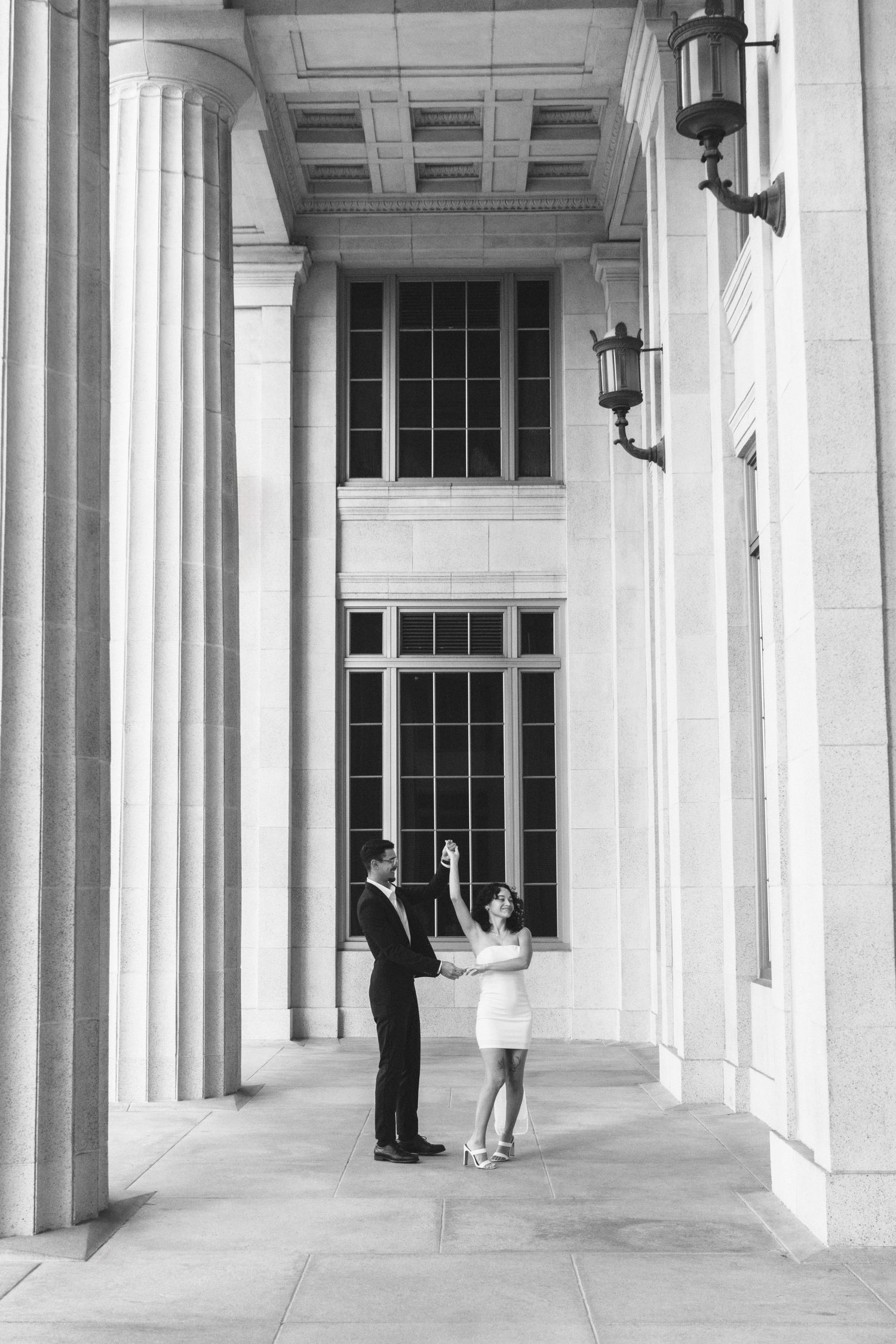 Miami engagement (elopement/mini wedding) photoshoot – groom twirling bride under courthouse columns