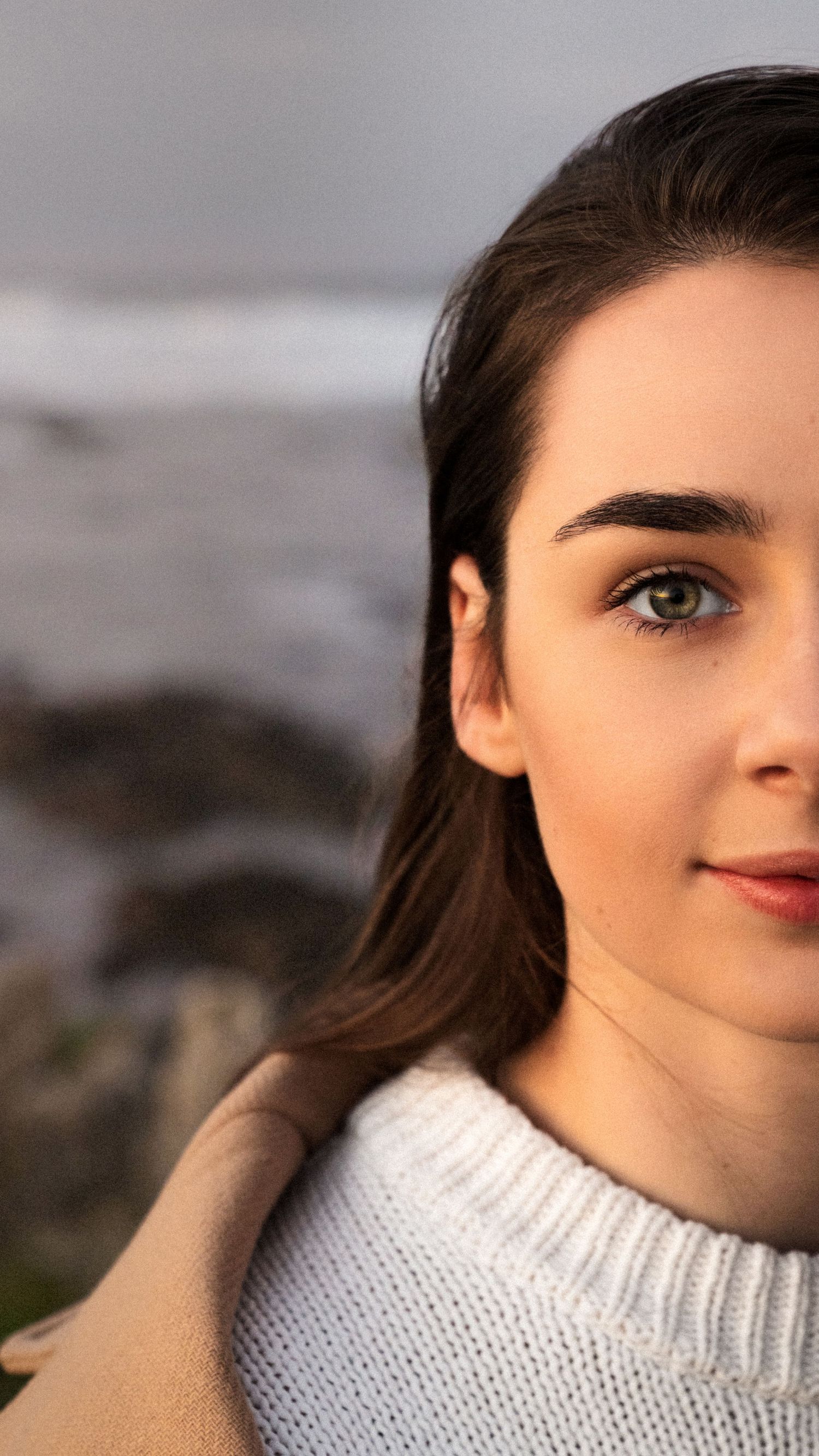 Close-up portrait of a woman, captured in a serene and intimate moment during a photoshoot
