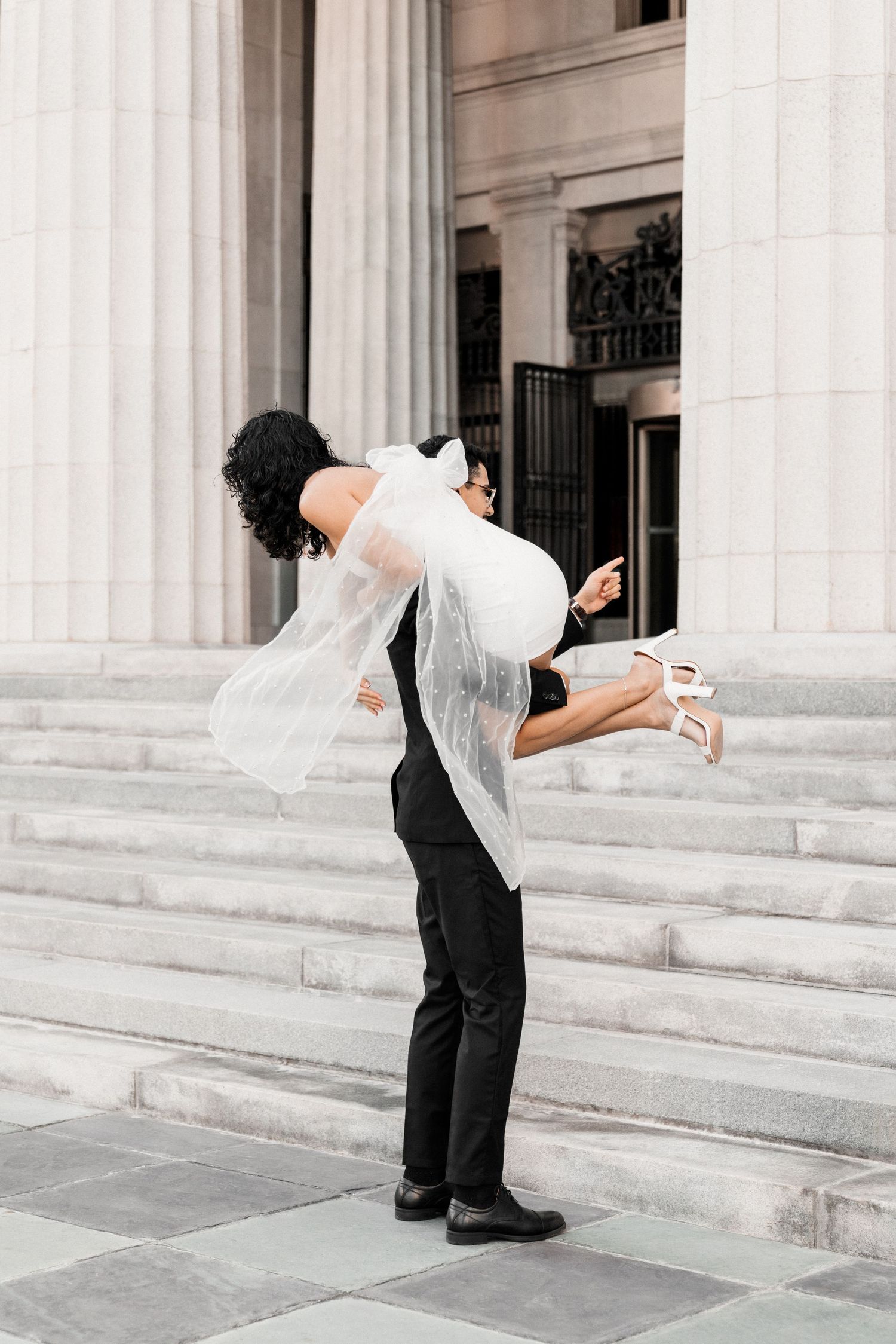 Intimate Miami courthouse engagement photoshoot – groom lifting bride in his arms