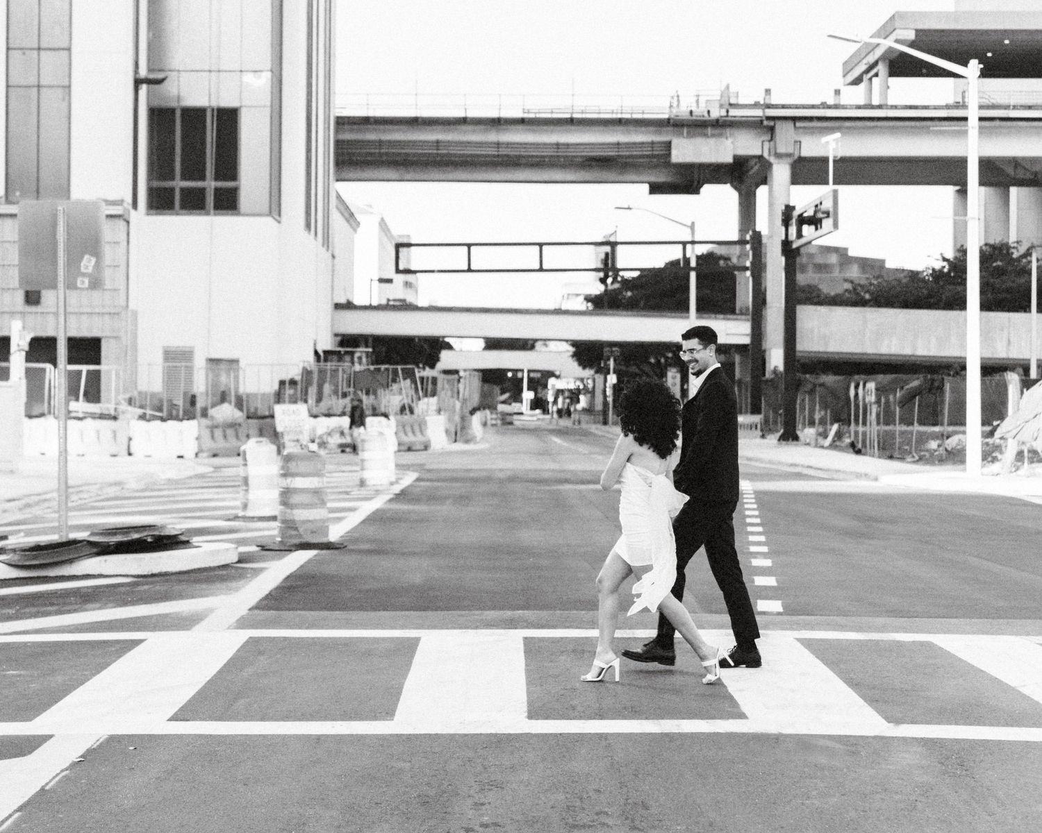 Miami engagement (elopement/mini wedding) photoshoot – couple laughing while crossing the street