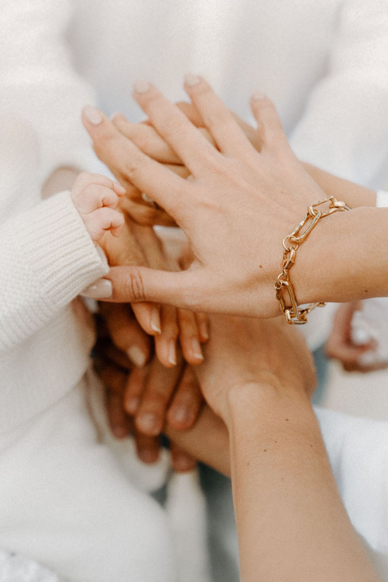 Miami lifestyle photoshoot – family stacking hands together in an intimate moment