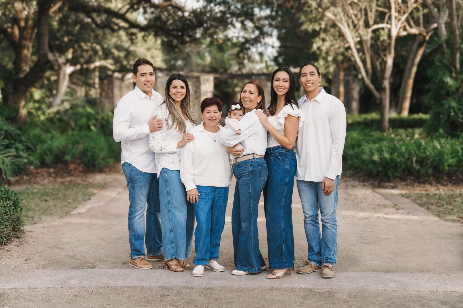 Multi-generational family portrait in a Miami park – joyful moment with baby adding warmth