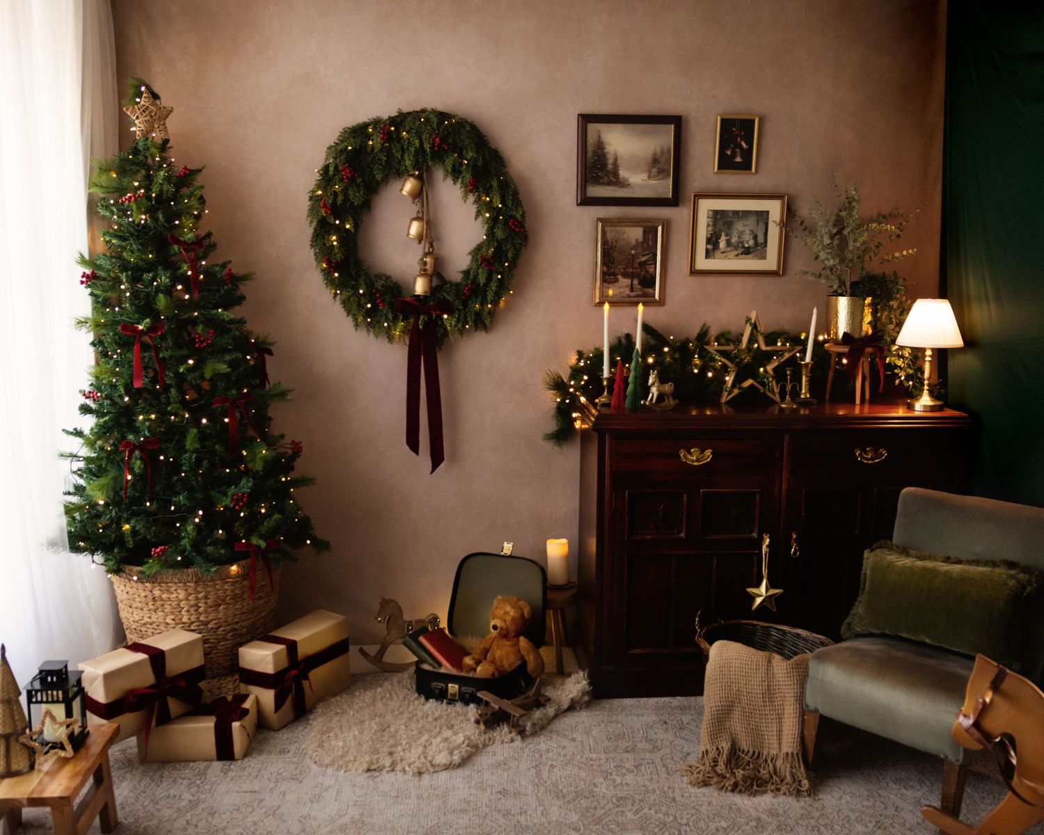 Cozy Christmas living room with decorated tree, wreath, candles, gifts, teddy bear, and armchair in warm holiday decor.