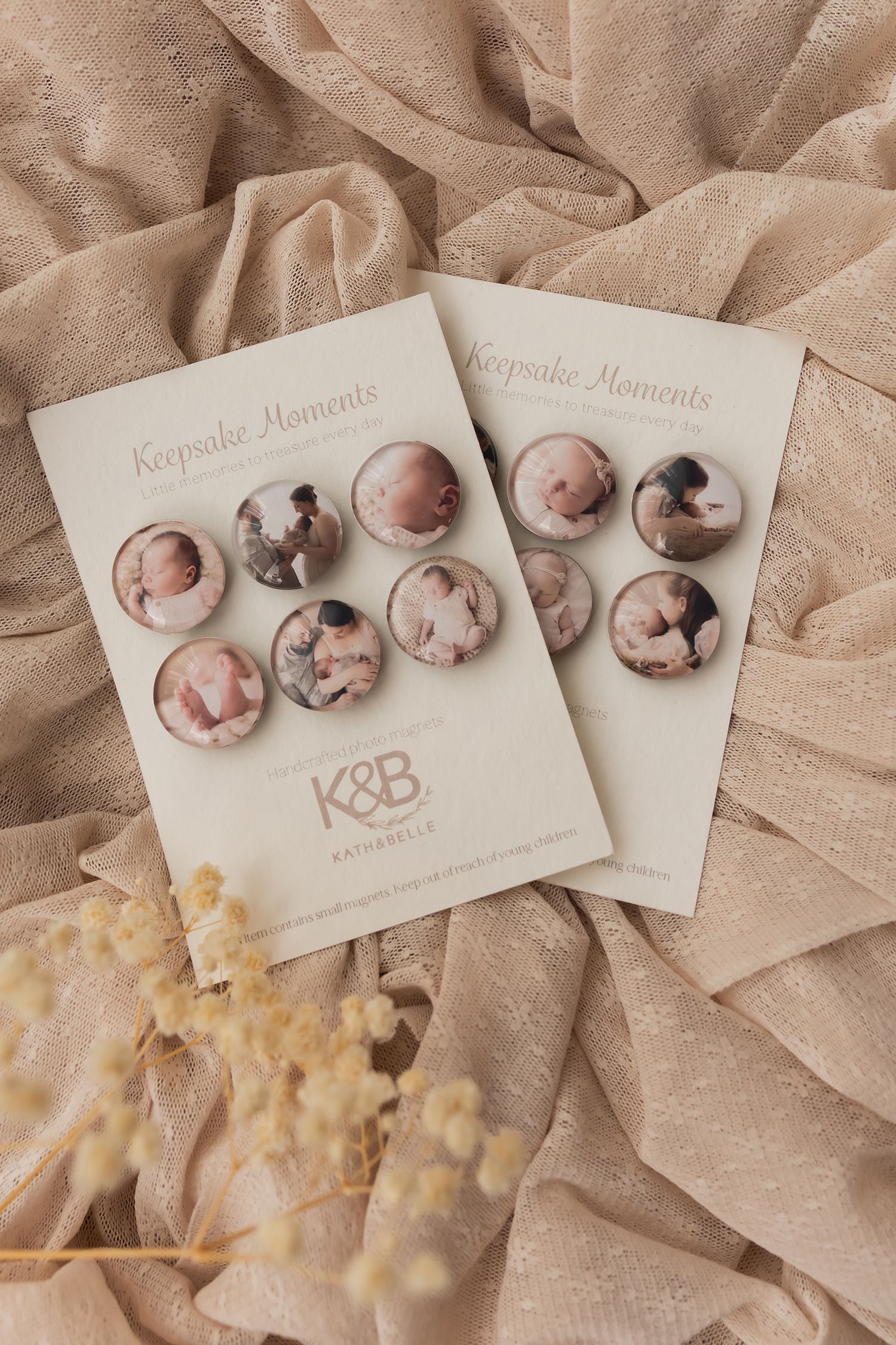 Two Keepsake Moments photo button sets by K&B Kathabella displayed on cream cards with newborn photos.