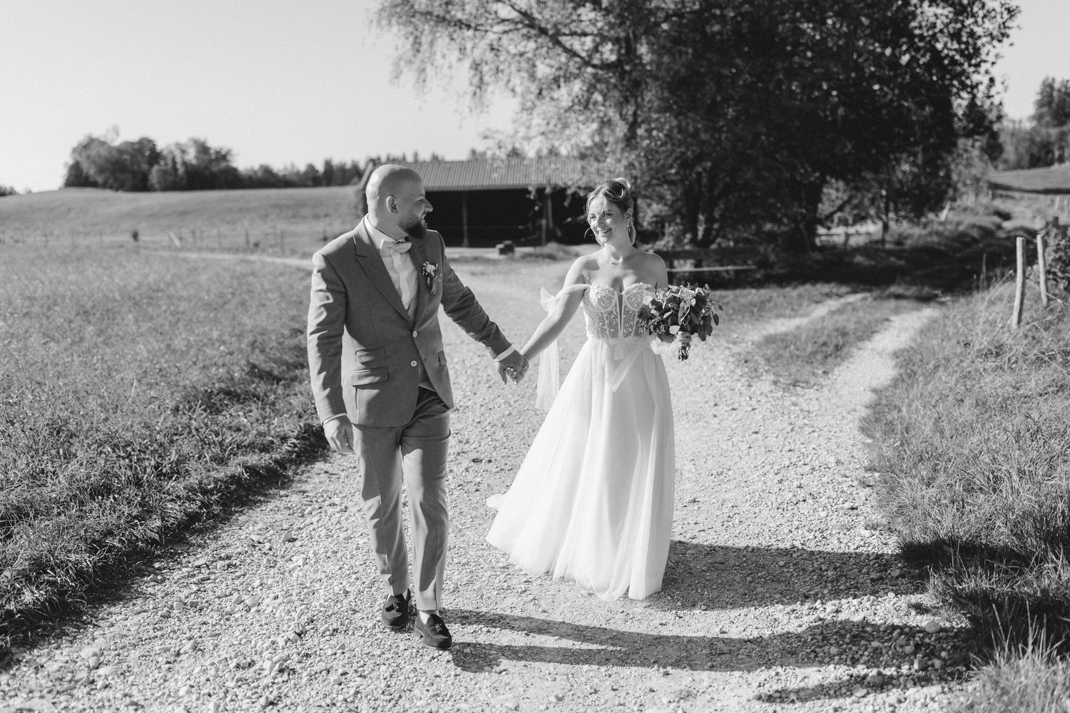Black and white collage of newlyweds walking together on a country path through romantic outdoor settings.