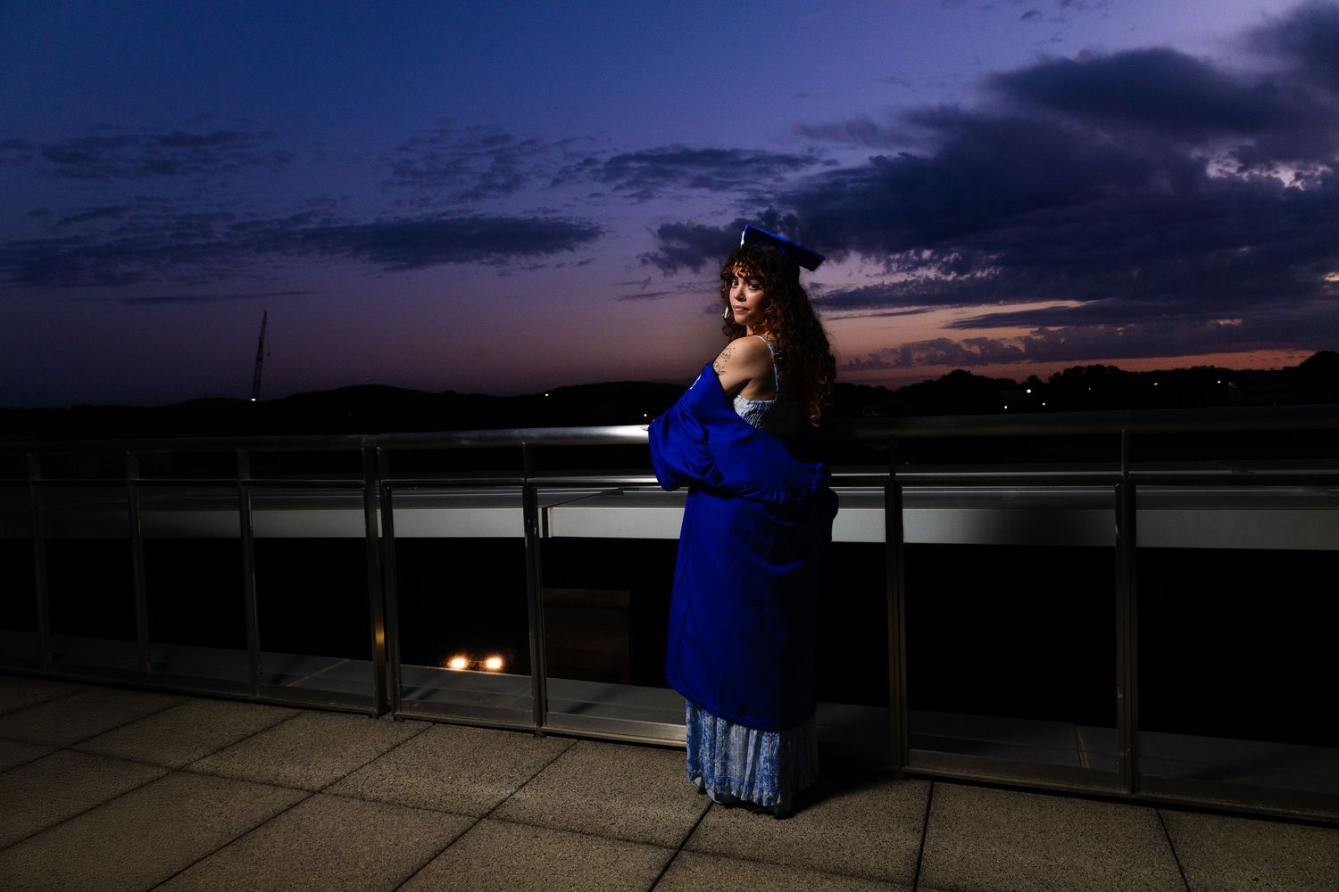 A series of evening sky photos showing a person in blue sitting on a ledge at dusk overlooking a scenic landscape.