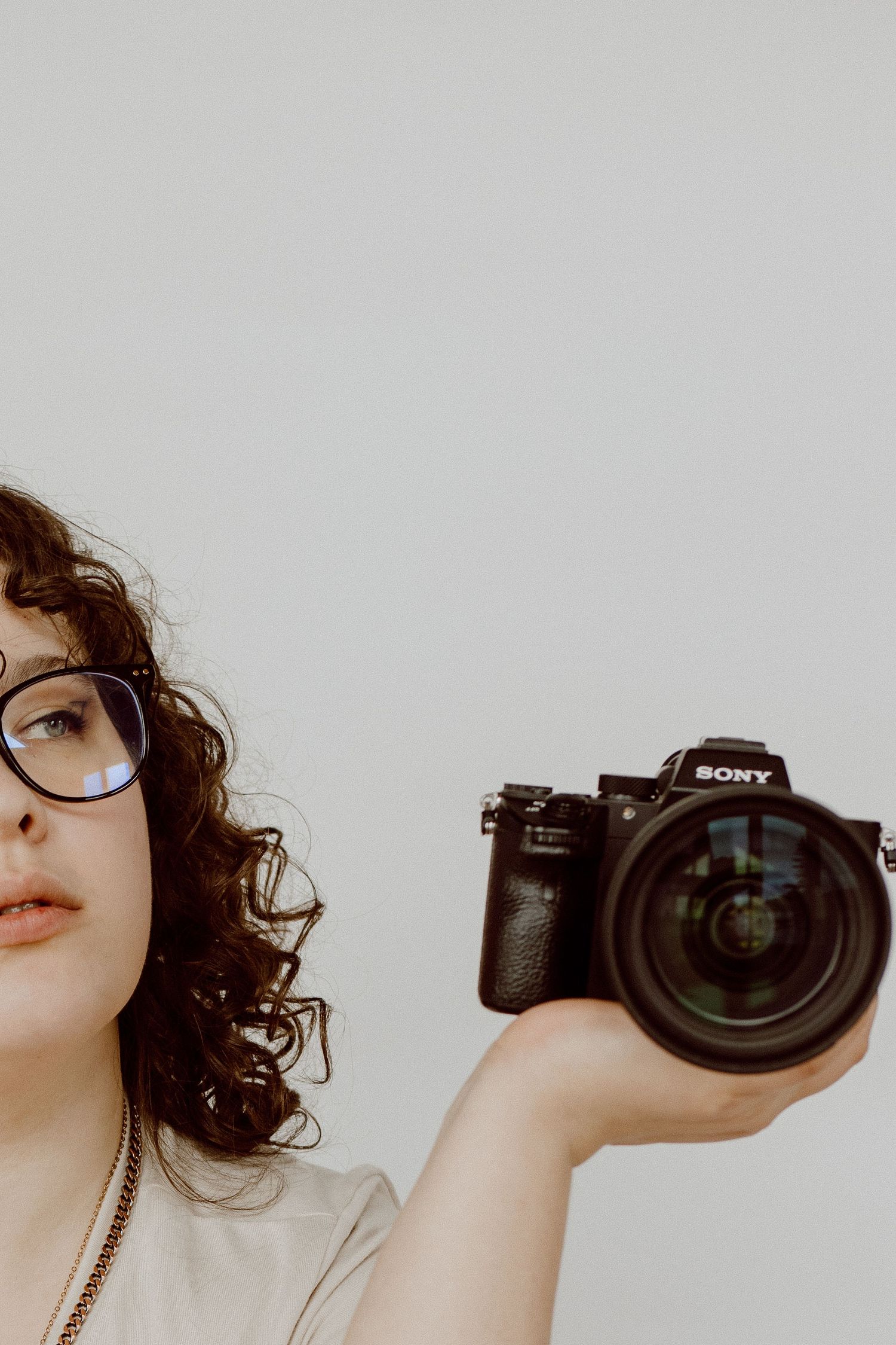 Series of shots with a Sony camera being held against white background.