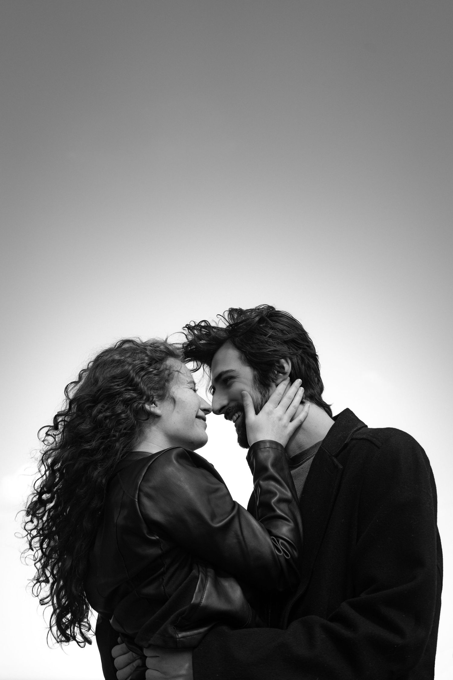 Artistic black and white silhouettes of a couple in an intimate moment.