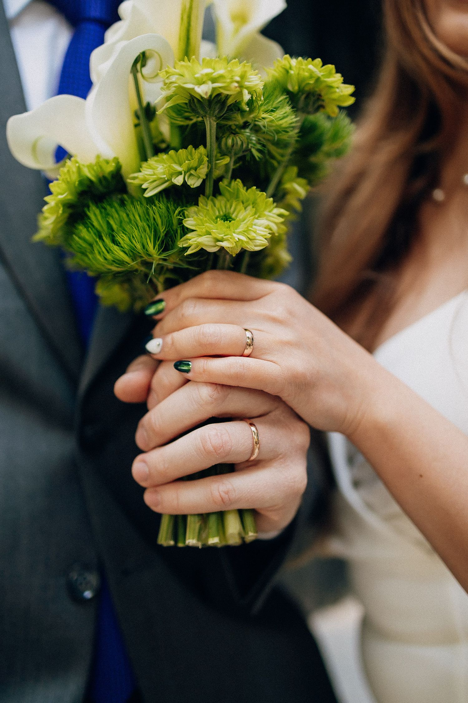 A series of close-up shots showing hands holding a green and white floral bouquet with wedding rings visible.