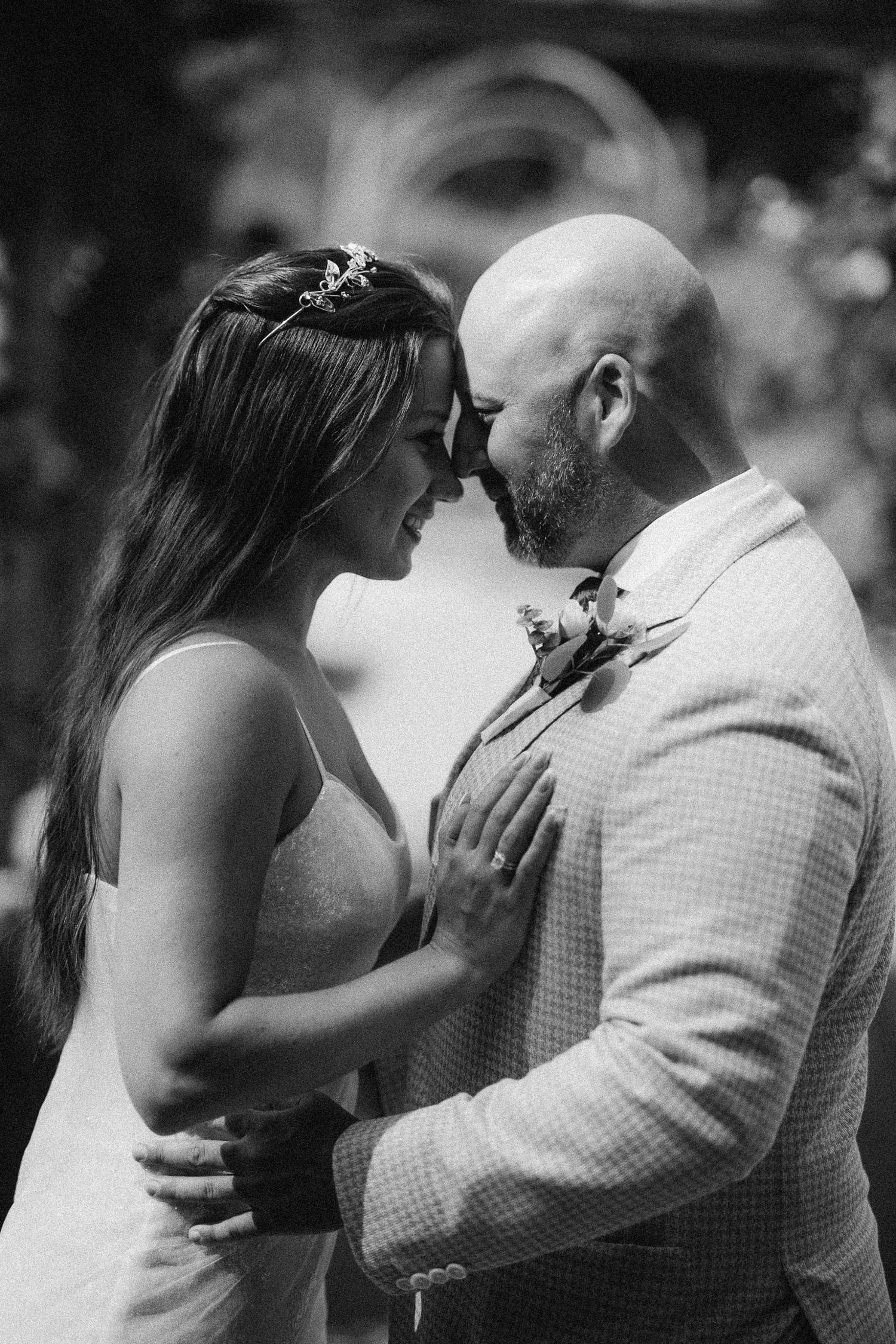 A romantic black and white photo sequence showing a couple sharing an intimate kiss in four progressive frames.