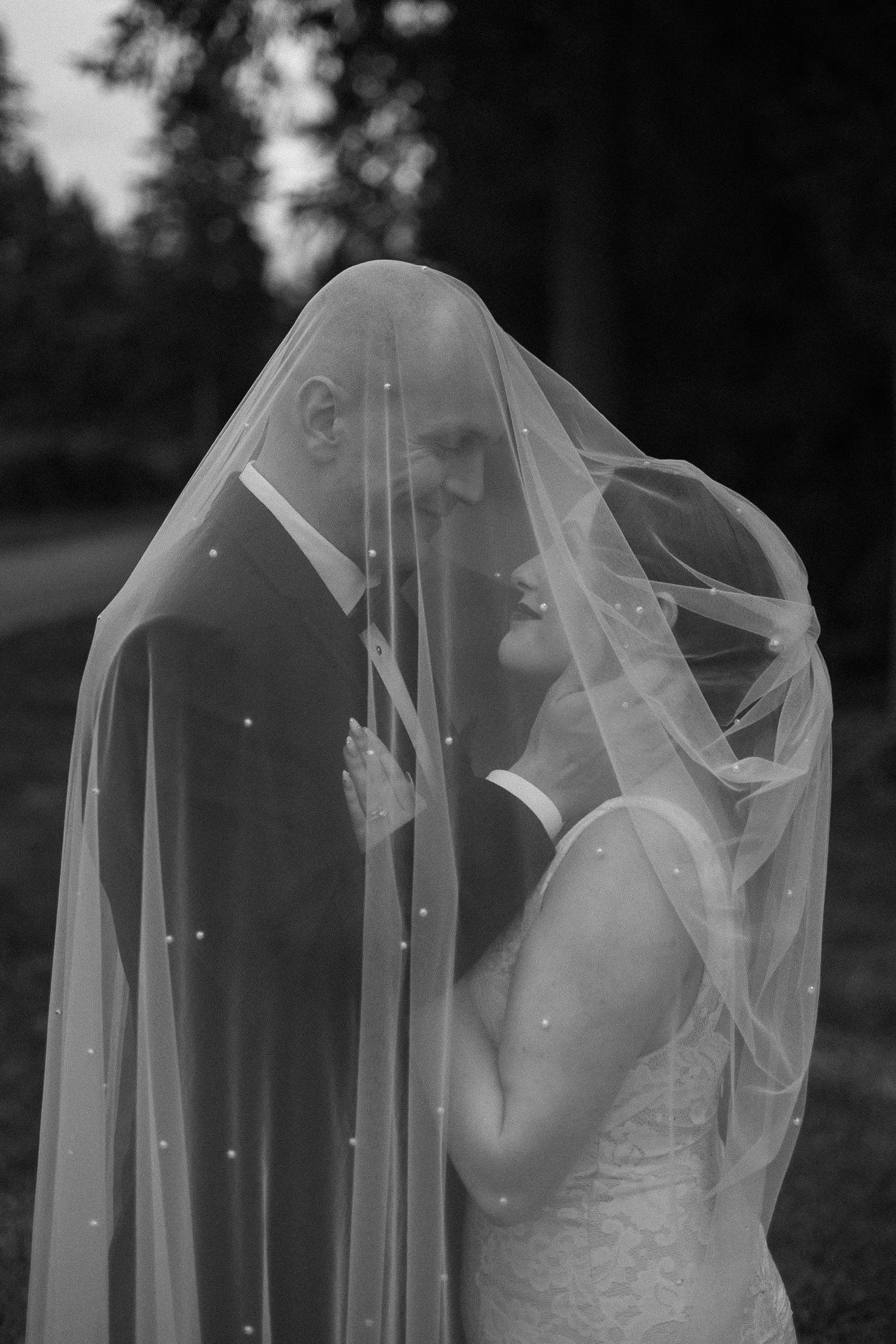 A romantic black and white photo sequence showing a bride in a veil with flowing fabric creating an ethereal effect.