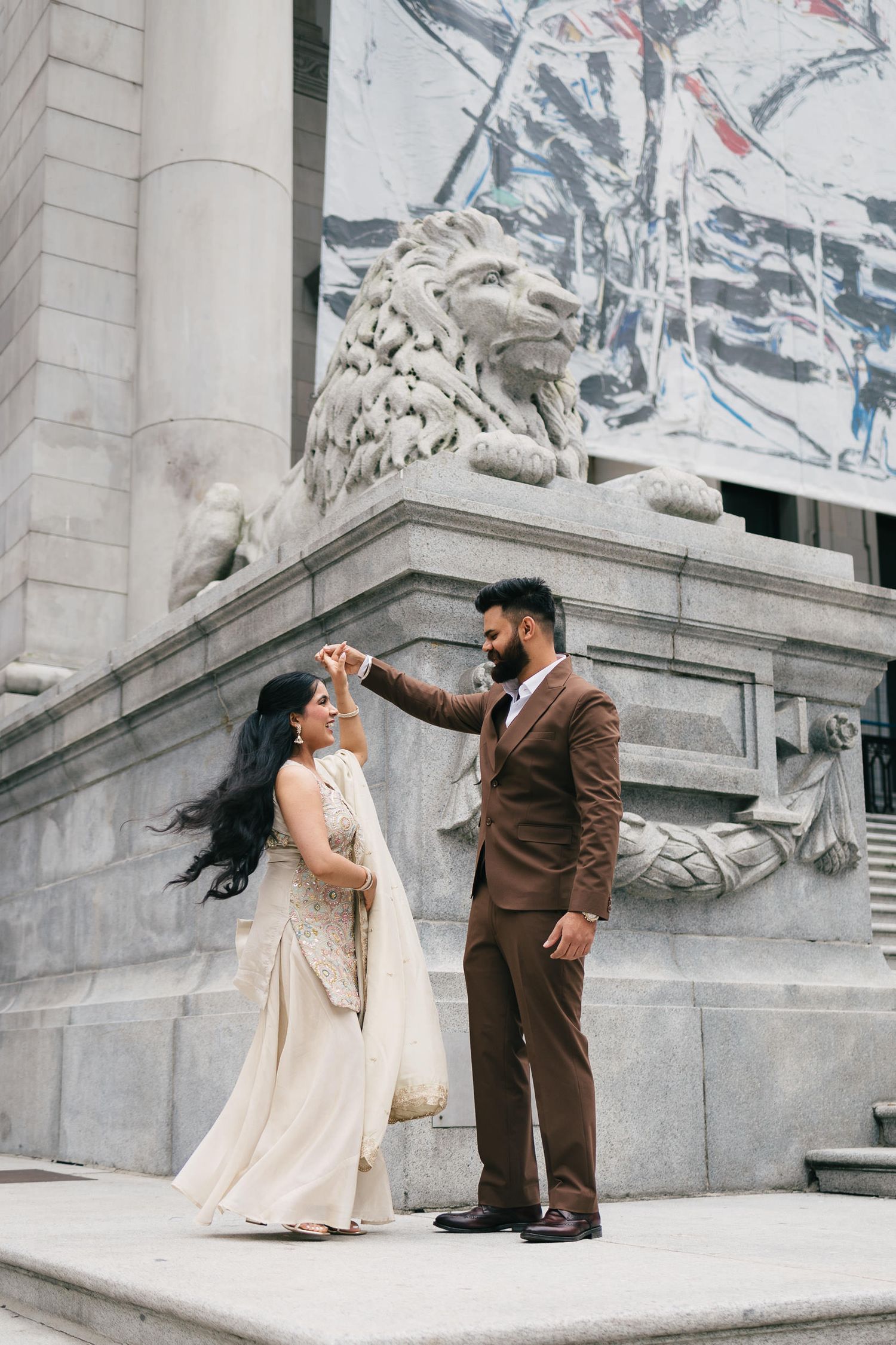 A romantic dance sequence captured on the steps of a classical building with ornate architectural details.