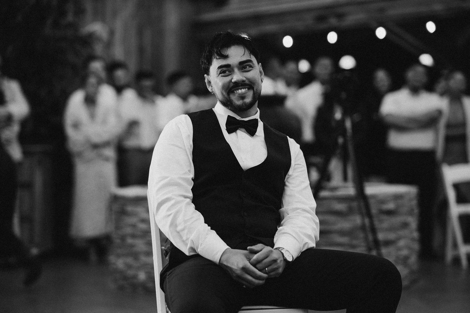 A sequence of black and white photos showing people dancing and celebrating at what appears to be a wedding reception.