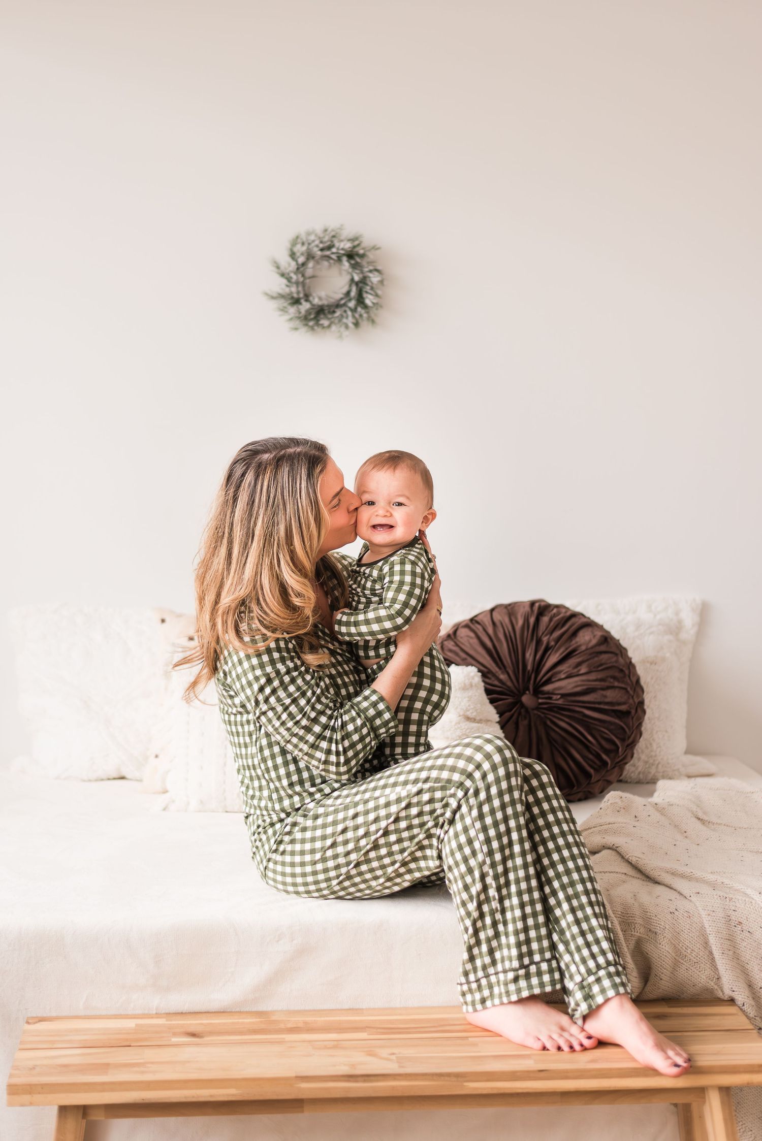 A person wearing a green checkered shirt lies on a wooden bench in a series of candid poses.