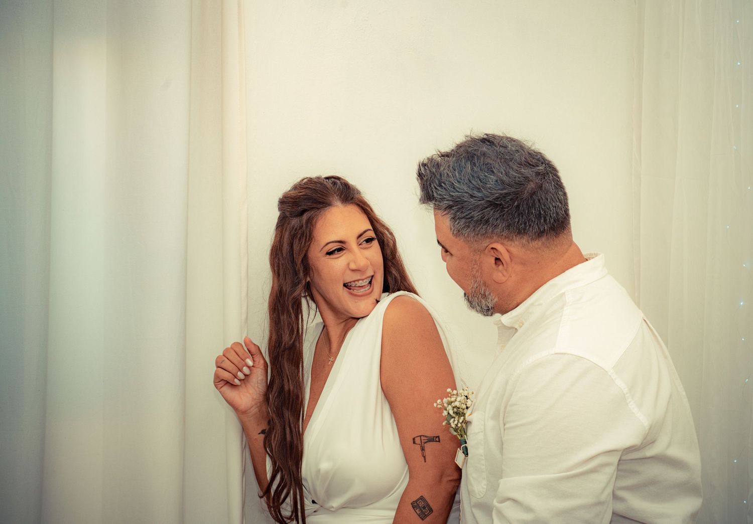 A couple in white clothing dance together in a series of romantic poses against a light background.