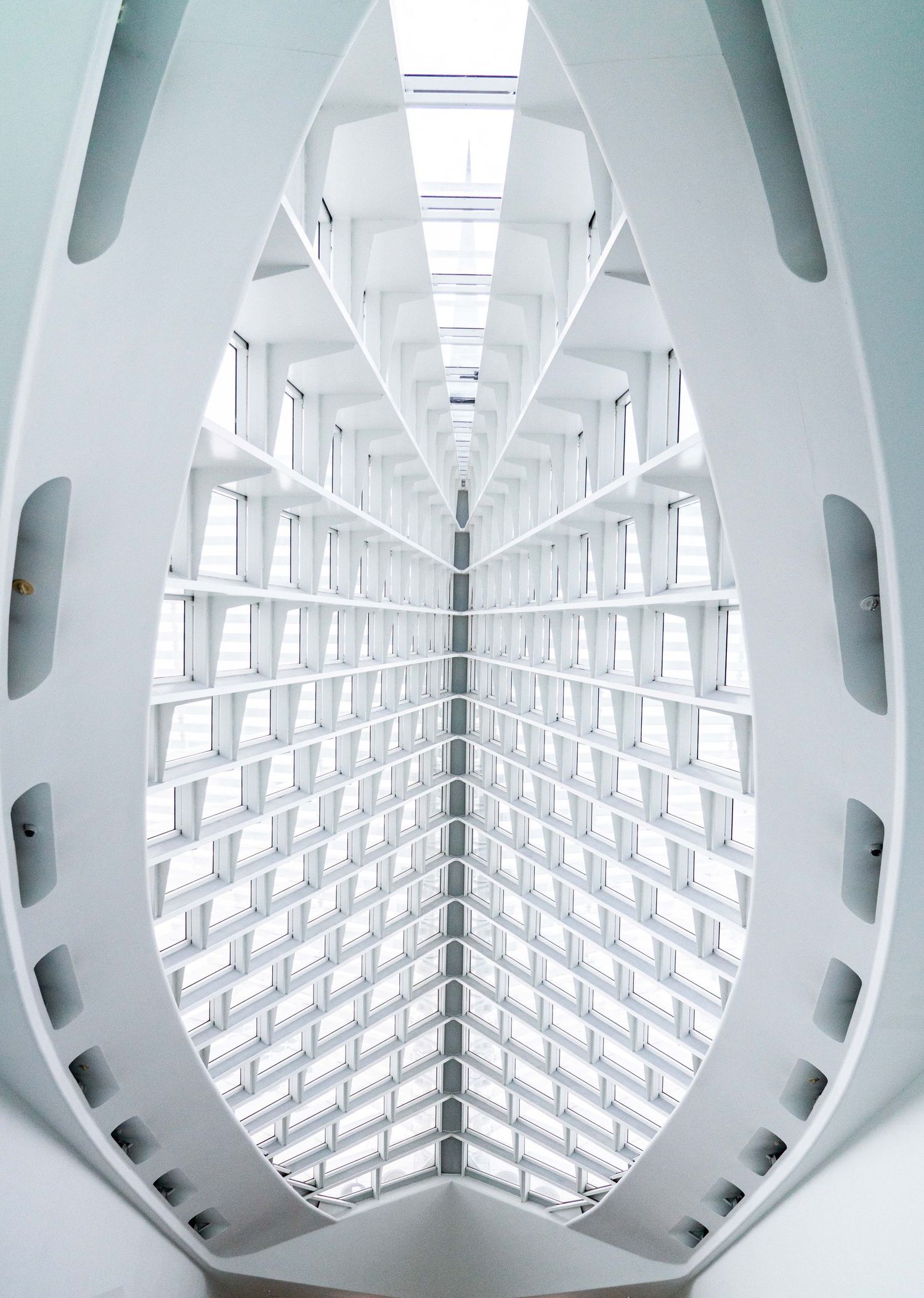 Modern white architectural interior with geometric patterns and symmetrical design.