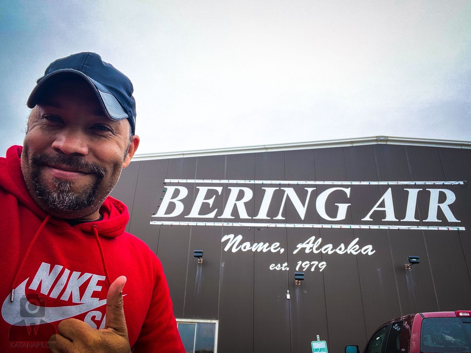 Bering Air facility and signage in Nome, Alaska against a cloudy sky.