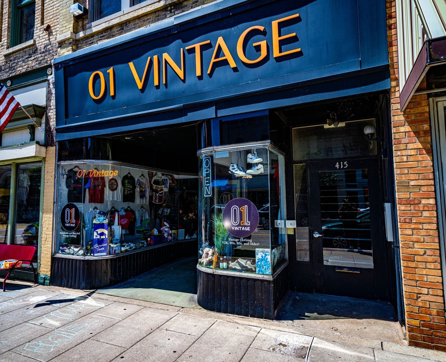 01 Vintage store exterior with dark blue signage and window display in historic building.