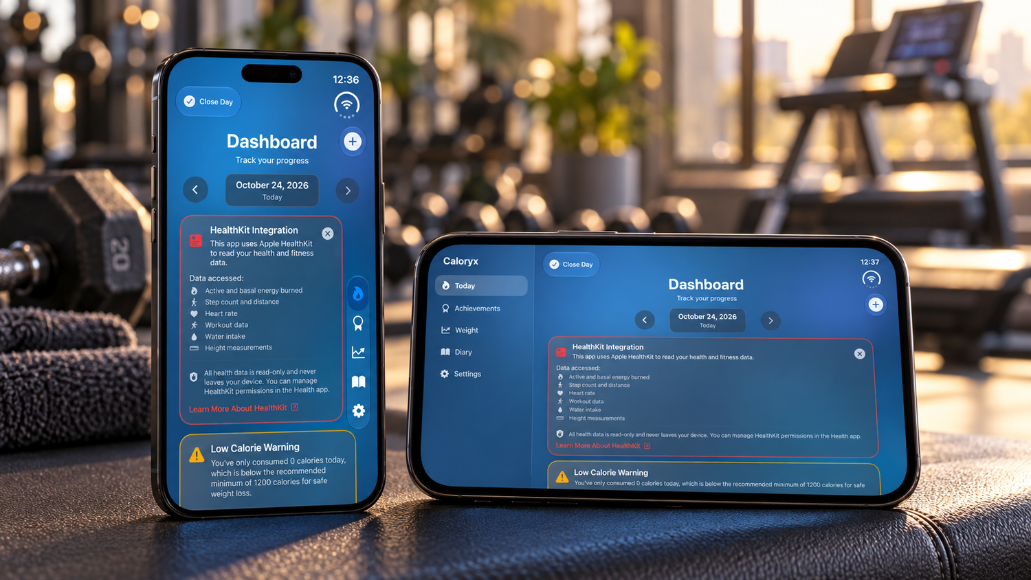 Two smartphones displaying a blue fitness dashboard app with alerts, resting on a gym bench near dumbbells and a treadmill.