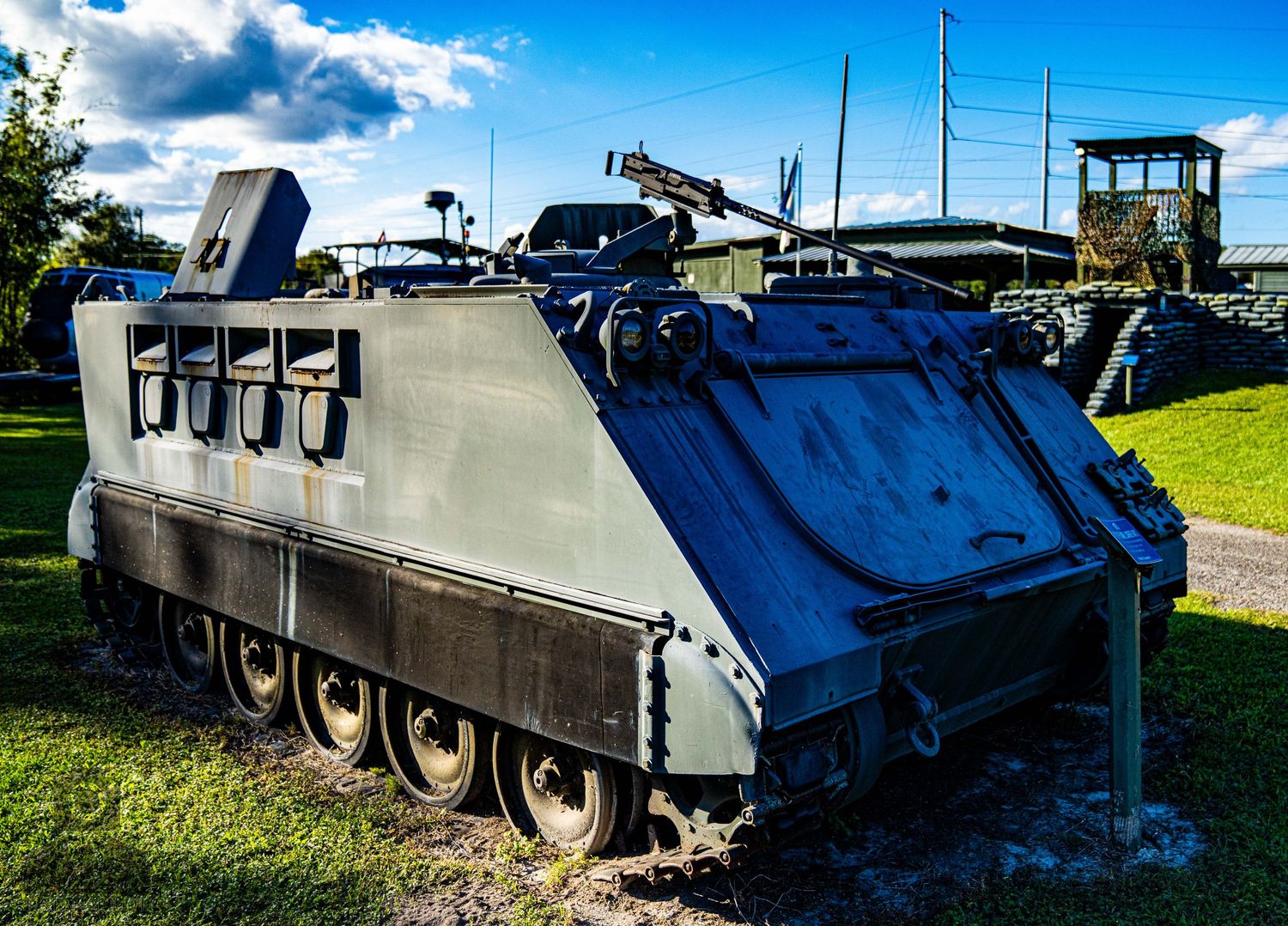 Line of armored military vehicles and tanks displayed at an outdoor military museum.