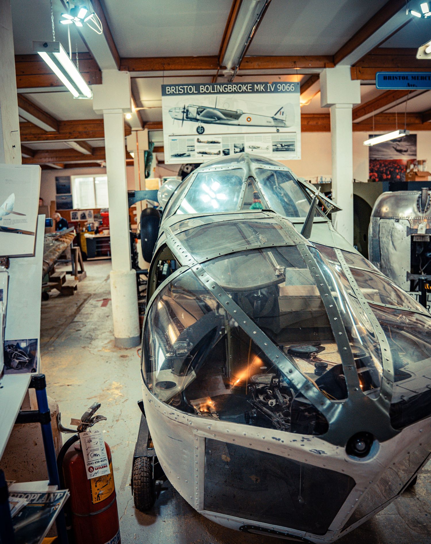 Interior view of multiple aircraft cockpits in an aviation museum display.