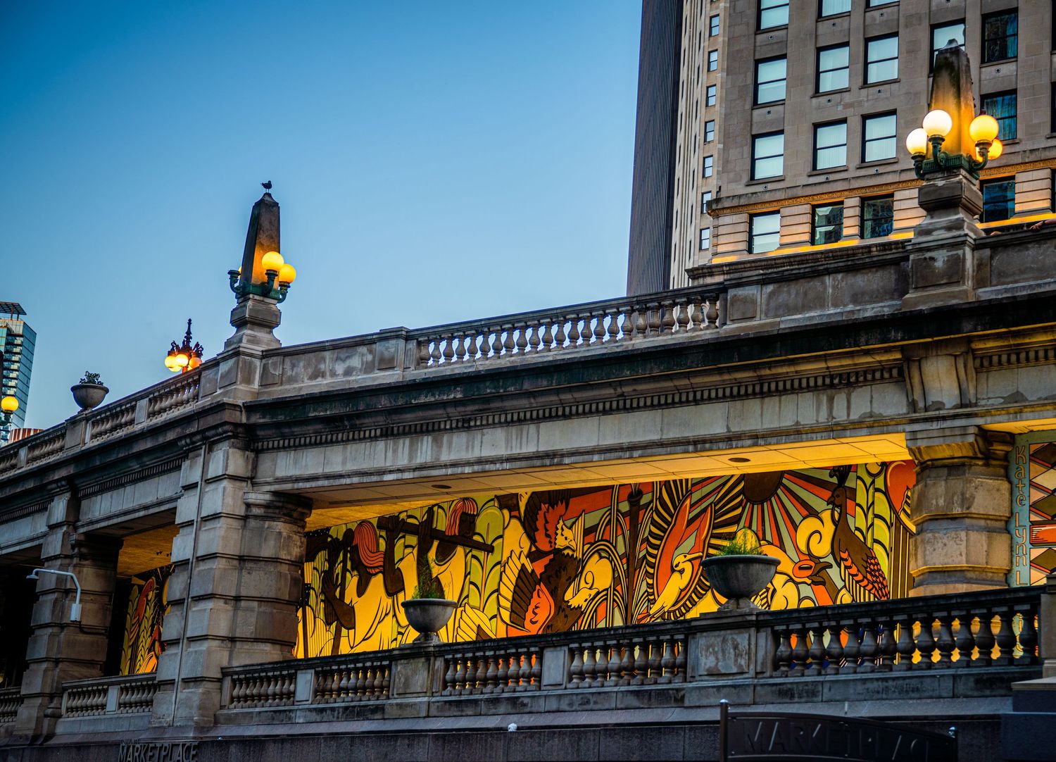 Historic Chicago bridge architecture illuminated with golden lights at dusk.