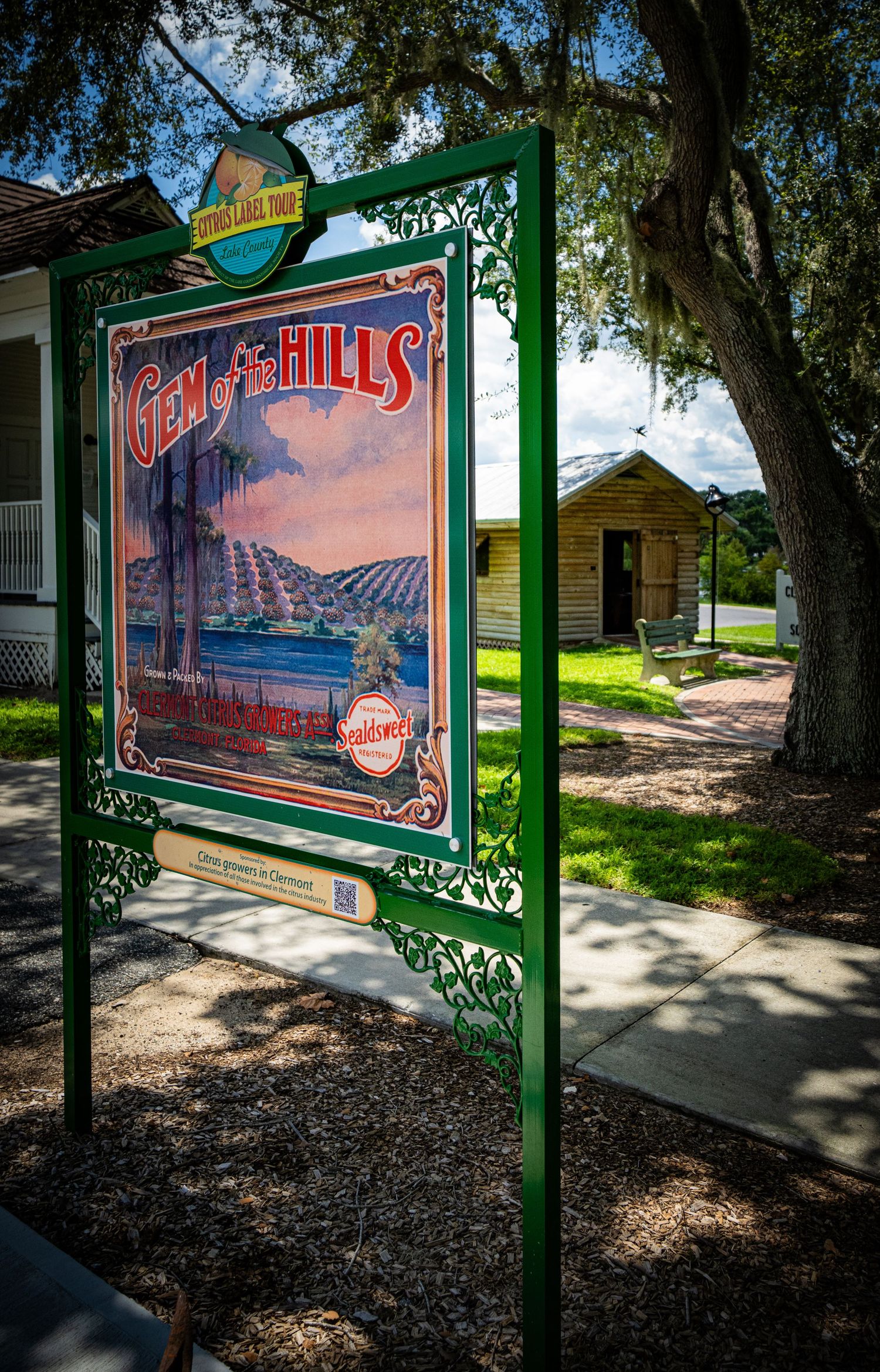 Outdoor display panels with vintage travel posters under shaded walkway.