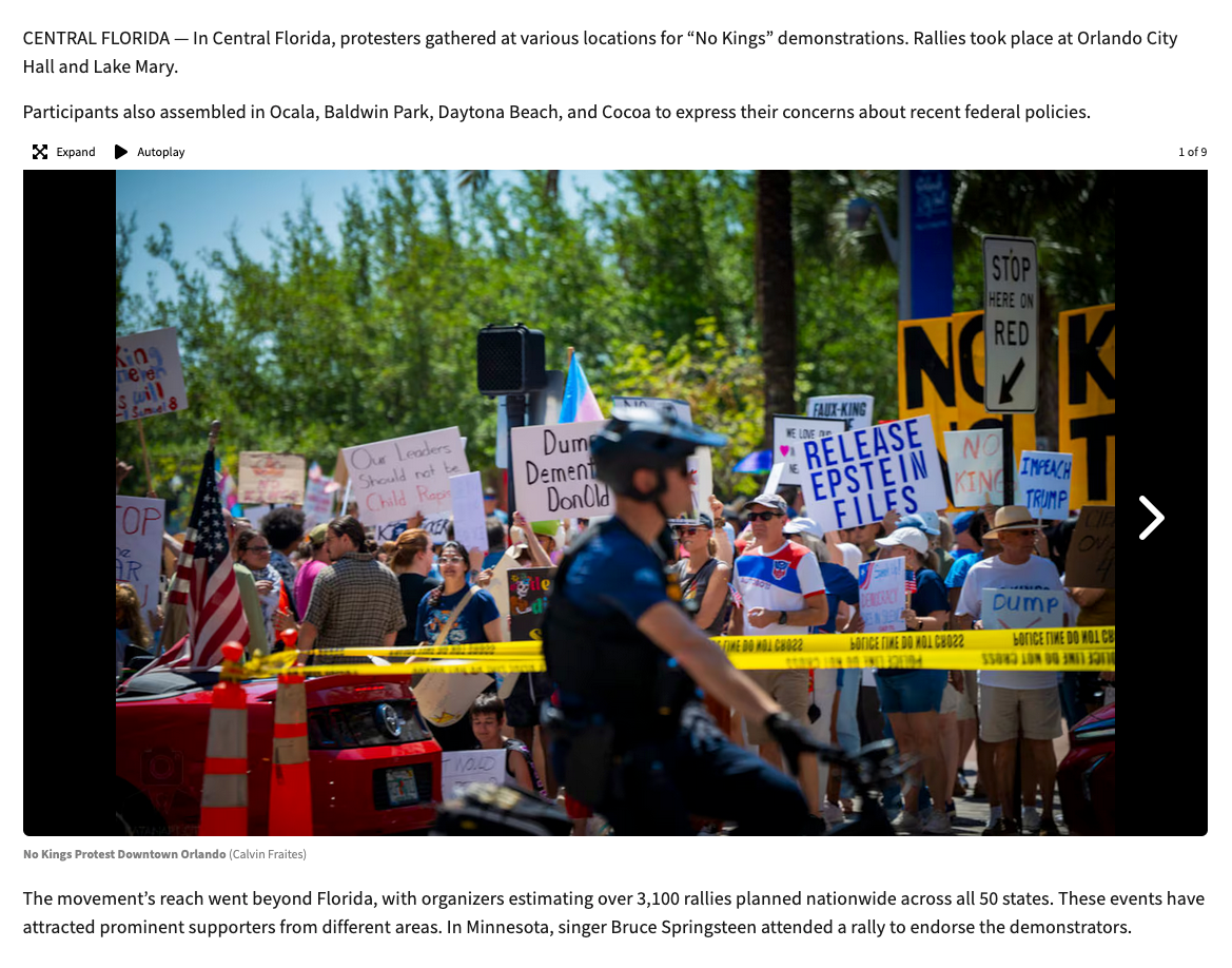 Protesters gather at a rally holding signs and banners while demonstrating in support of their cause during a sunny day.