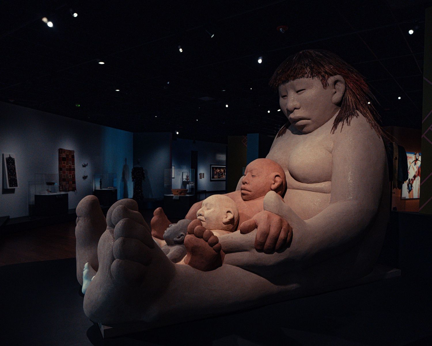 Dark moody installation art pieces displayed in dimly lit gallery spaces creating dramatic shadows and lighting effects.