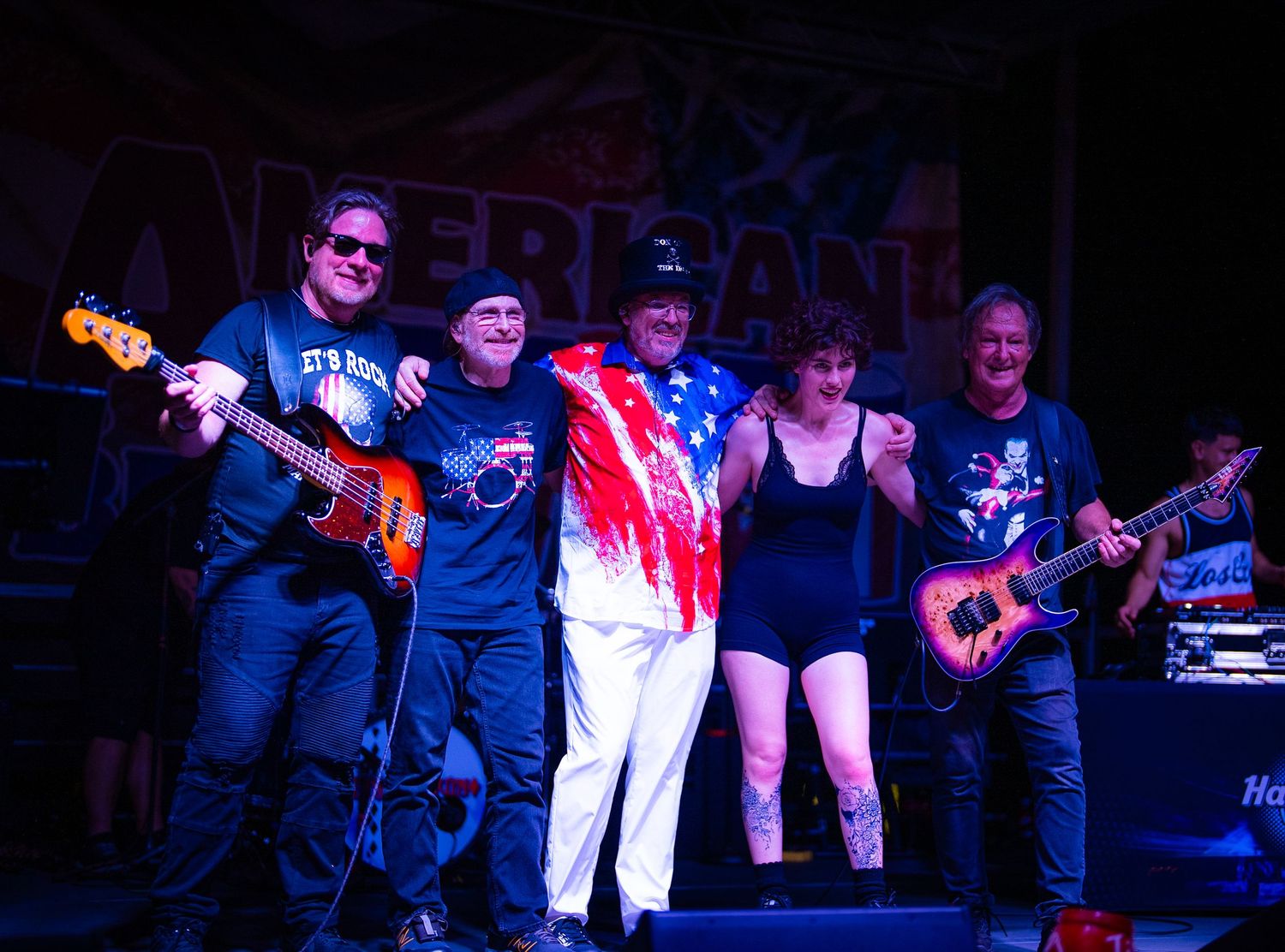 Concert performance on a dimly lit stage with colored lighting effects.